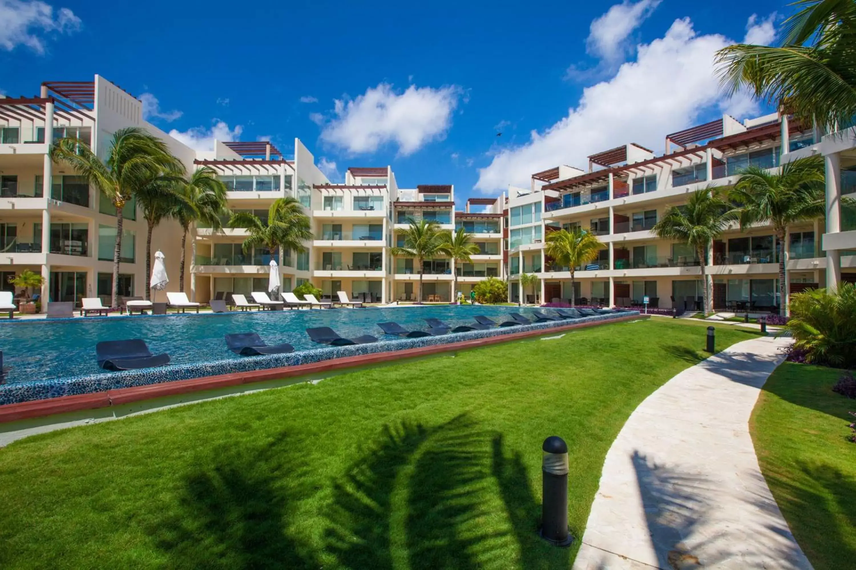Swimming pool, Property Building in The Elements Oceanfront & Beachside Condo Hotel