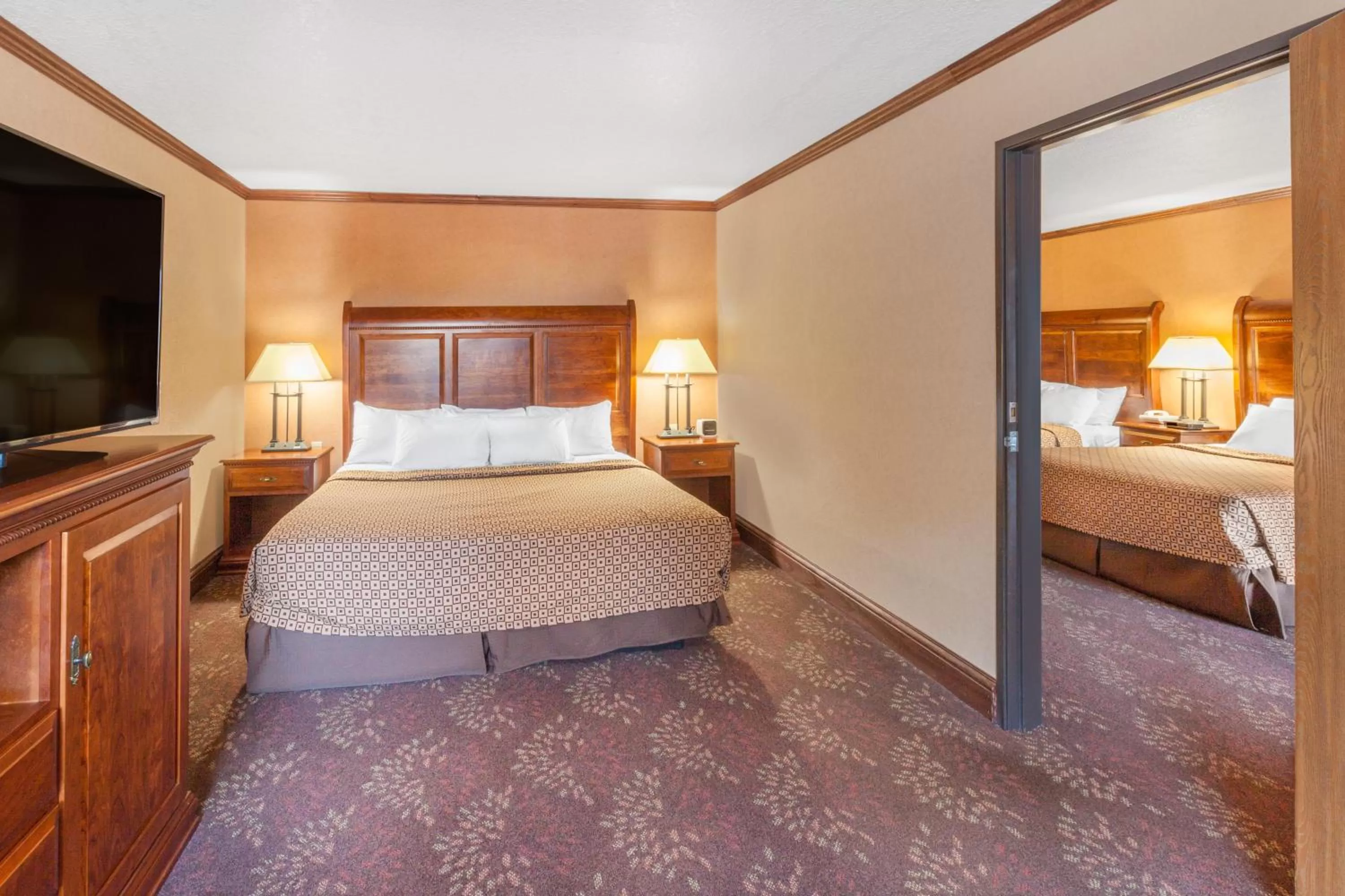 Photo of the whole room, Bed in Ramada by Wyndham Mackinaw City Waterfront