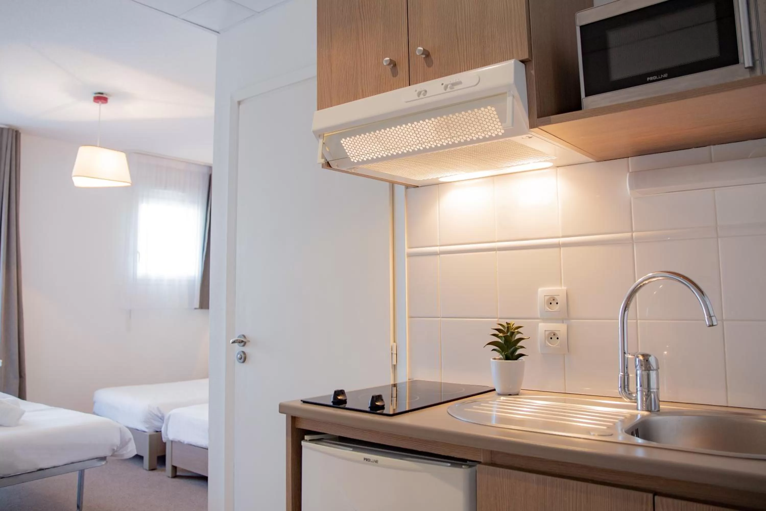 Kitchen or kitchenette, Bed in Comfort Aparthotel Cannes Mandelieu