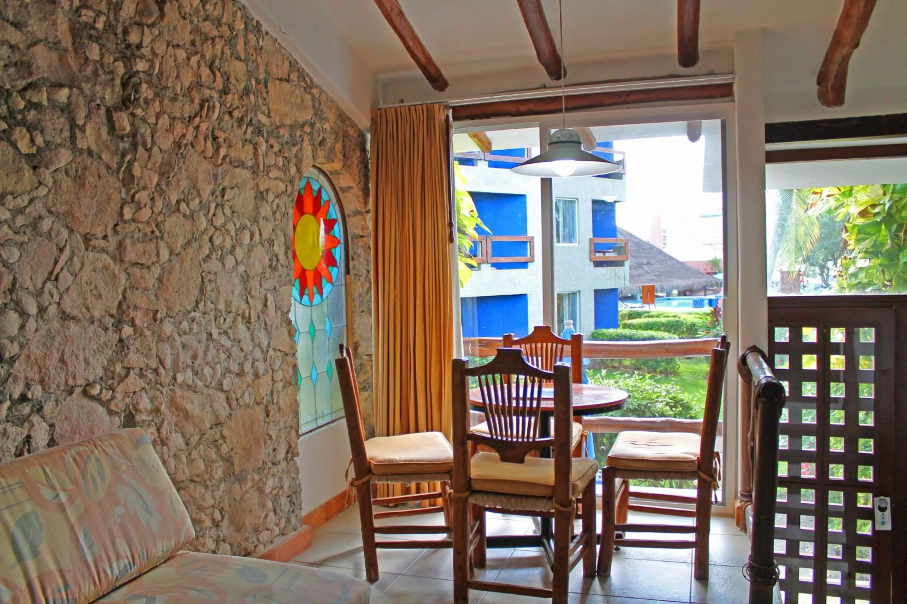 Seating area in Casa del Mar Cozumel Hotel & Dive Resort with free access to an exclusive beach club