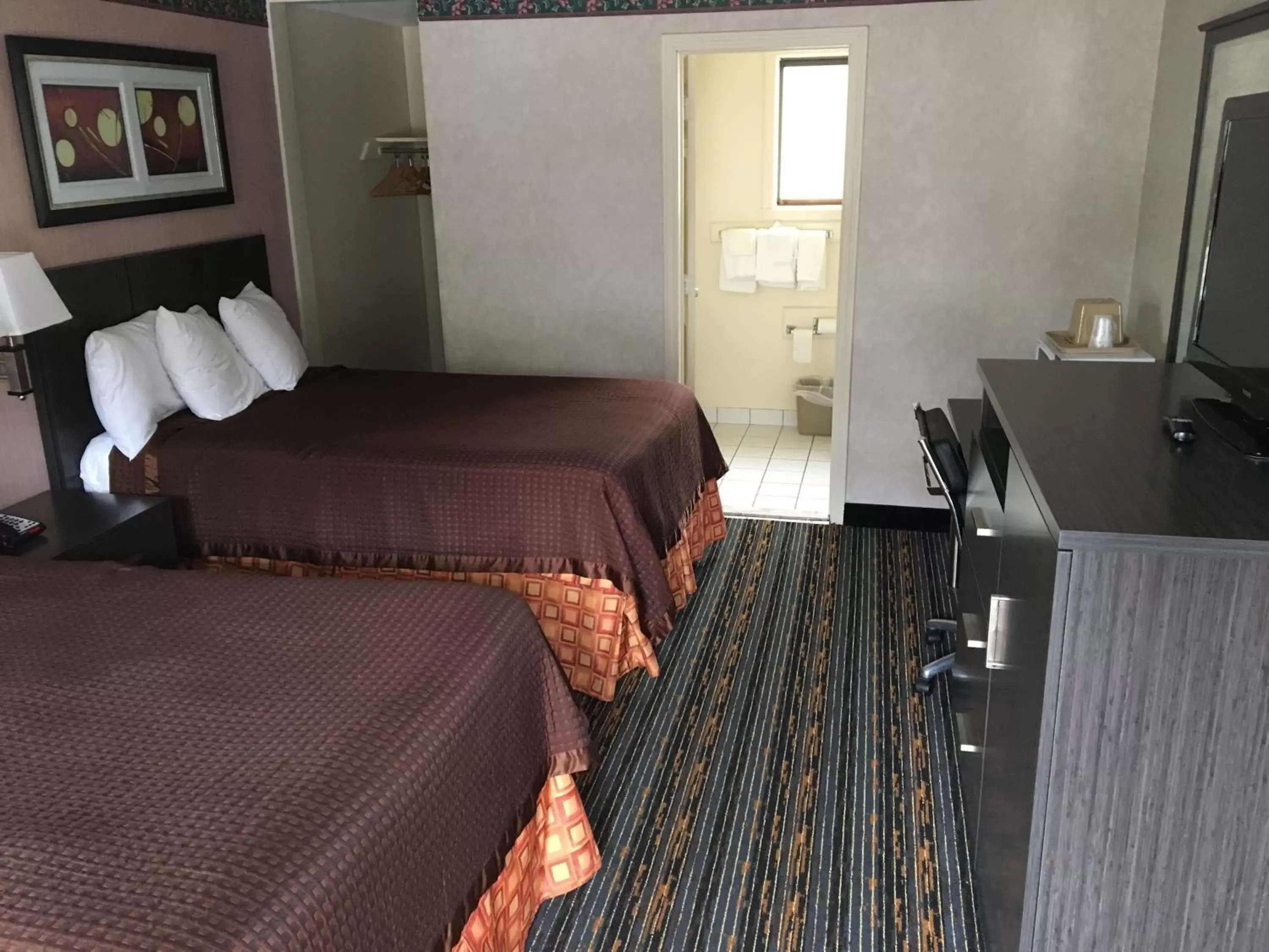 Bed in Whitney Inn & Suites Bed in Whitney Inn & Suites