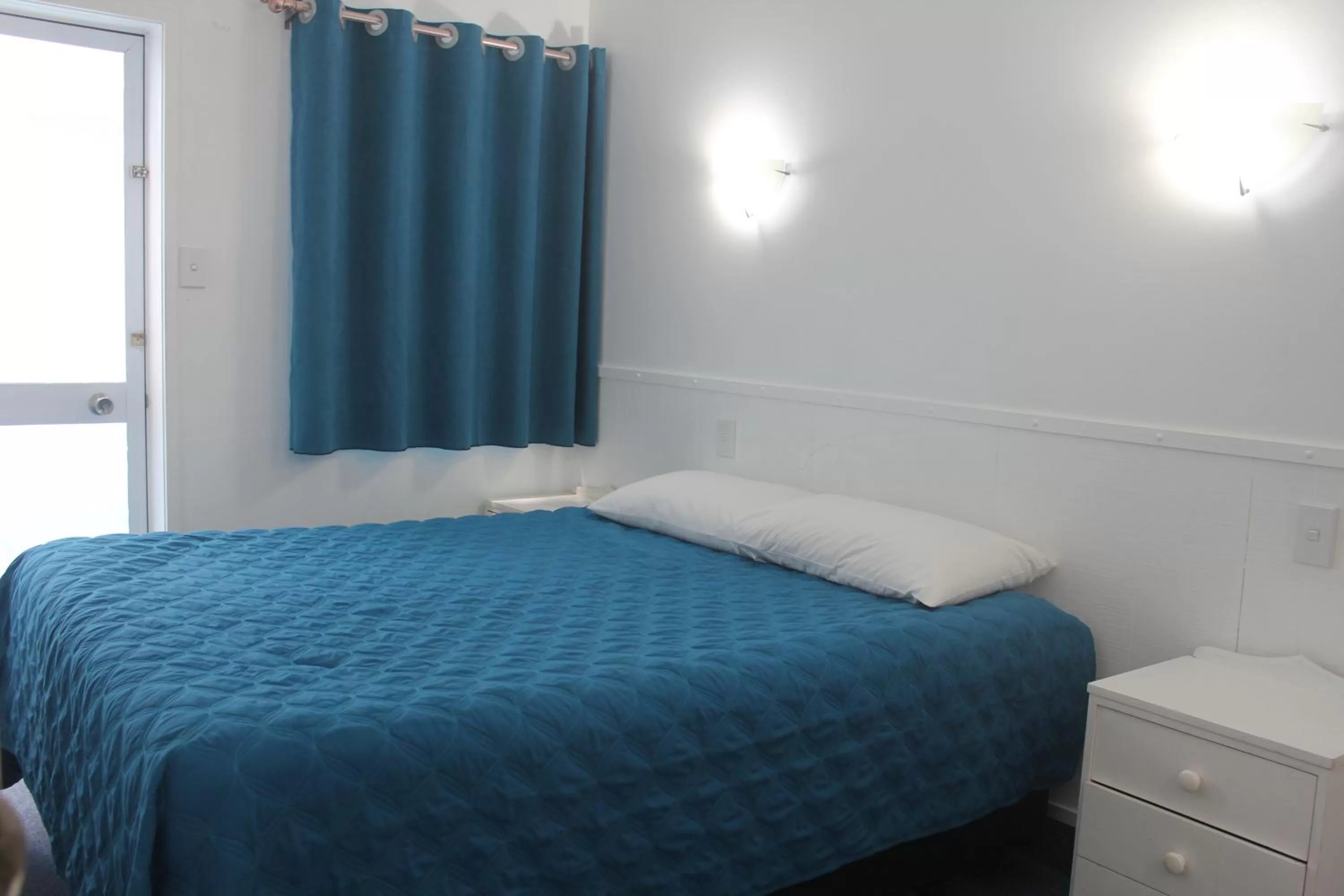 Bed in Golden Glow Motel