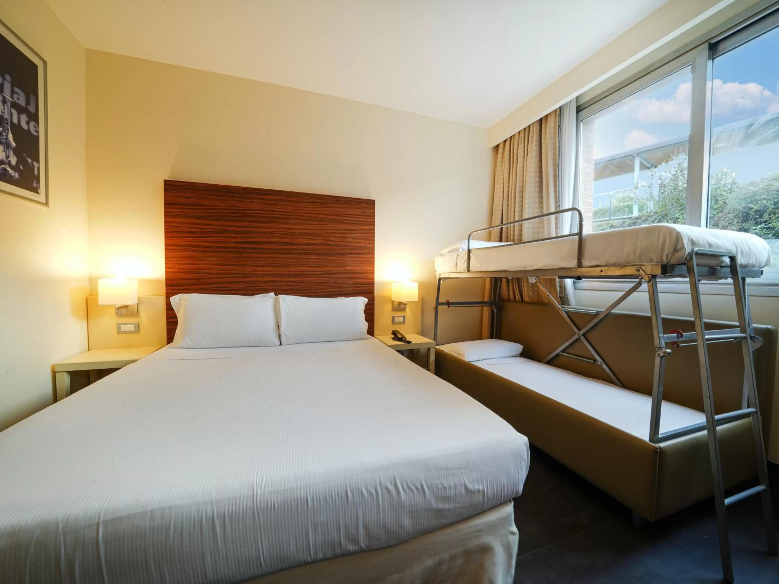 Bed in La Meridiana Bleisure Hotel