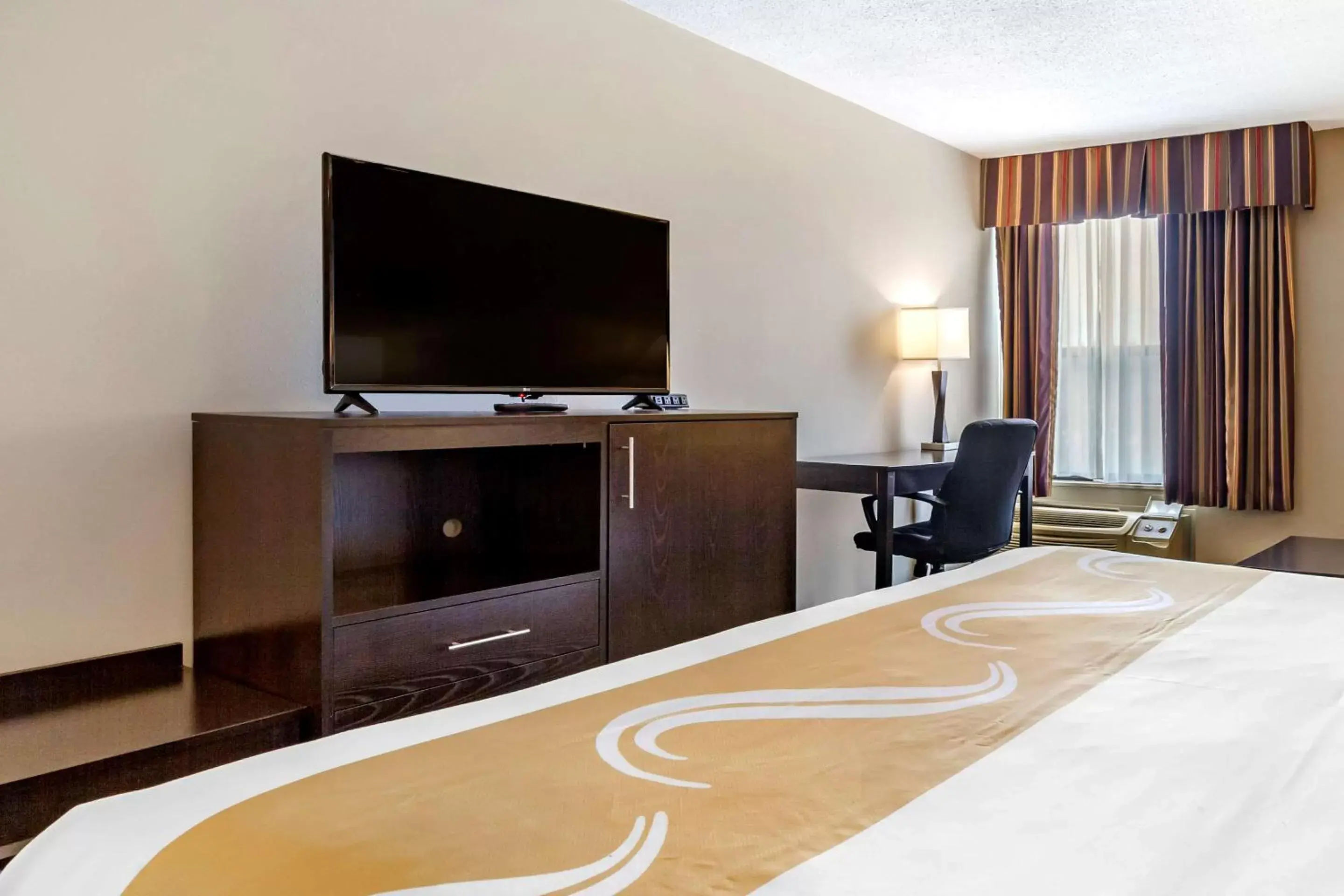 Photo of the whole room, TV/Entertainment Center in Quality Inn & Suites