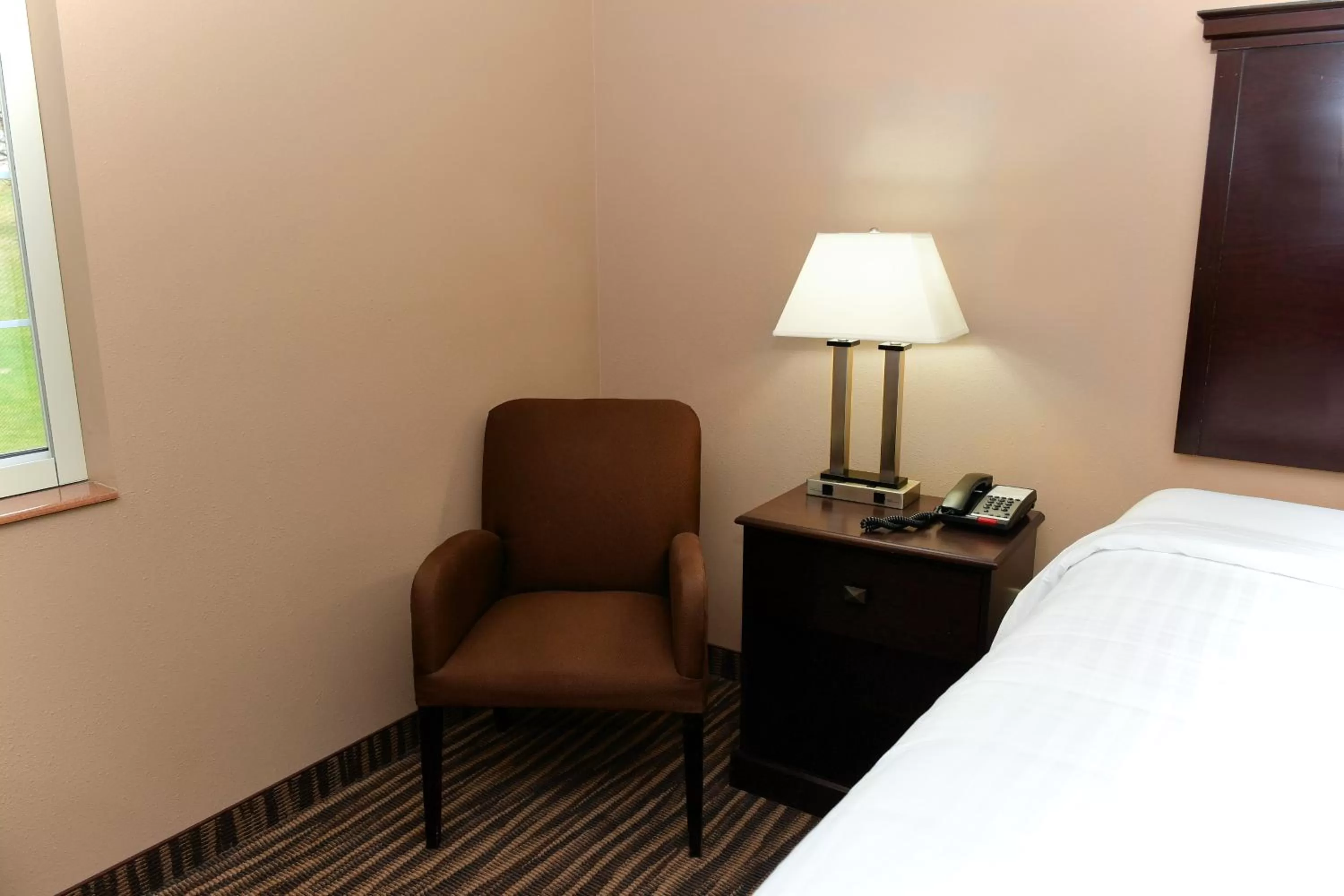 Bed in Cobblestone Inn & Suites - Denison | Majestic Hills