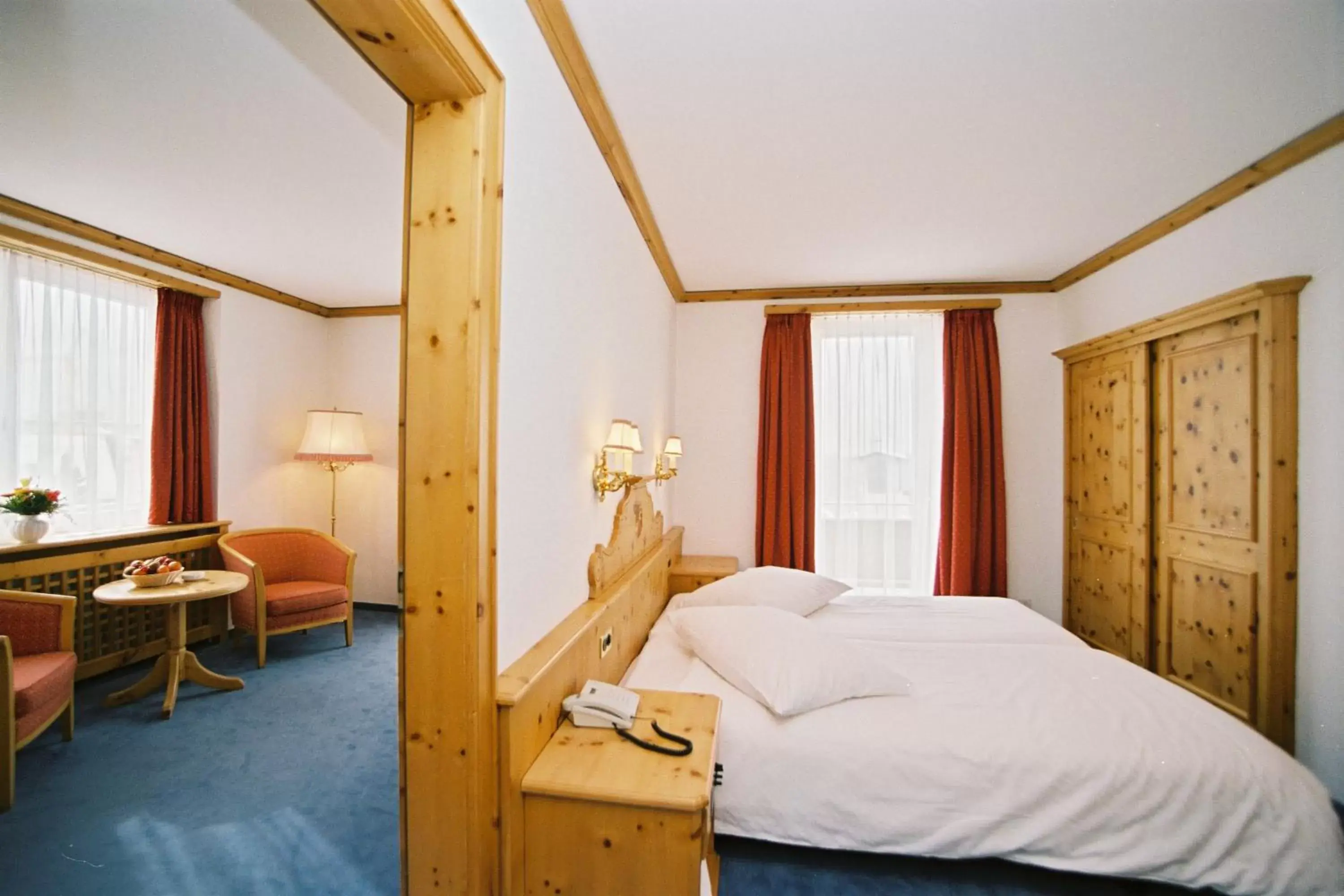 Photo of the whole room, Bed in Hotel Schweizerhof Pontresina