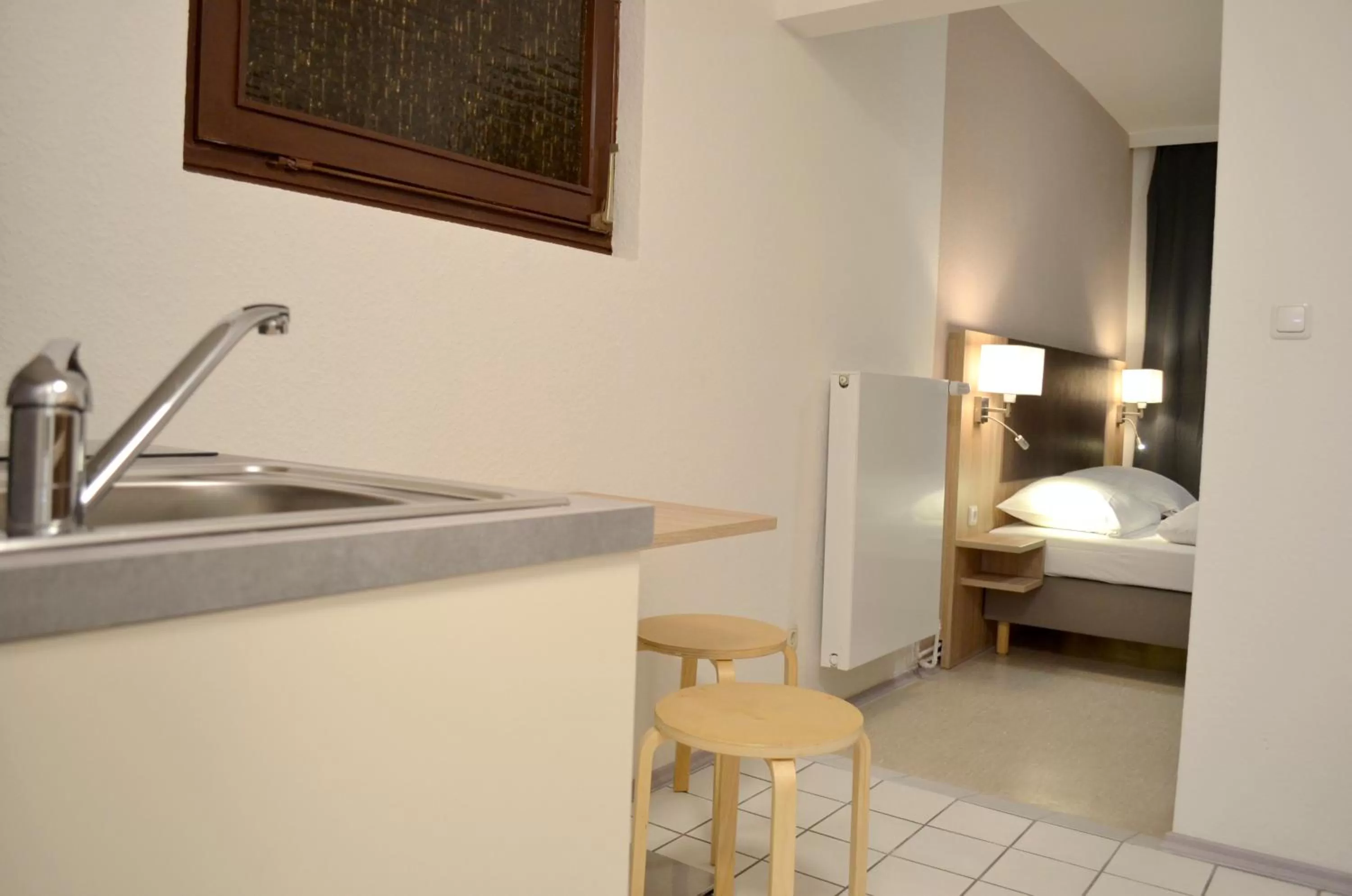 Kitchen or kitchenette, Bed in Hana Aparthotel