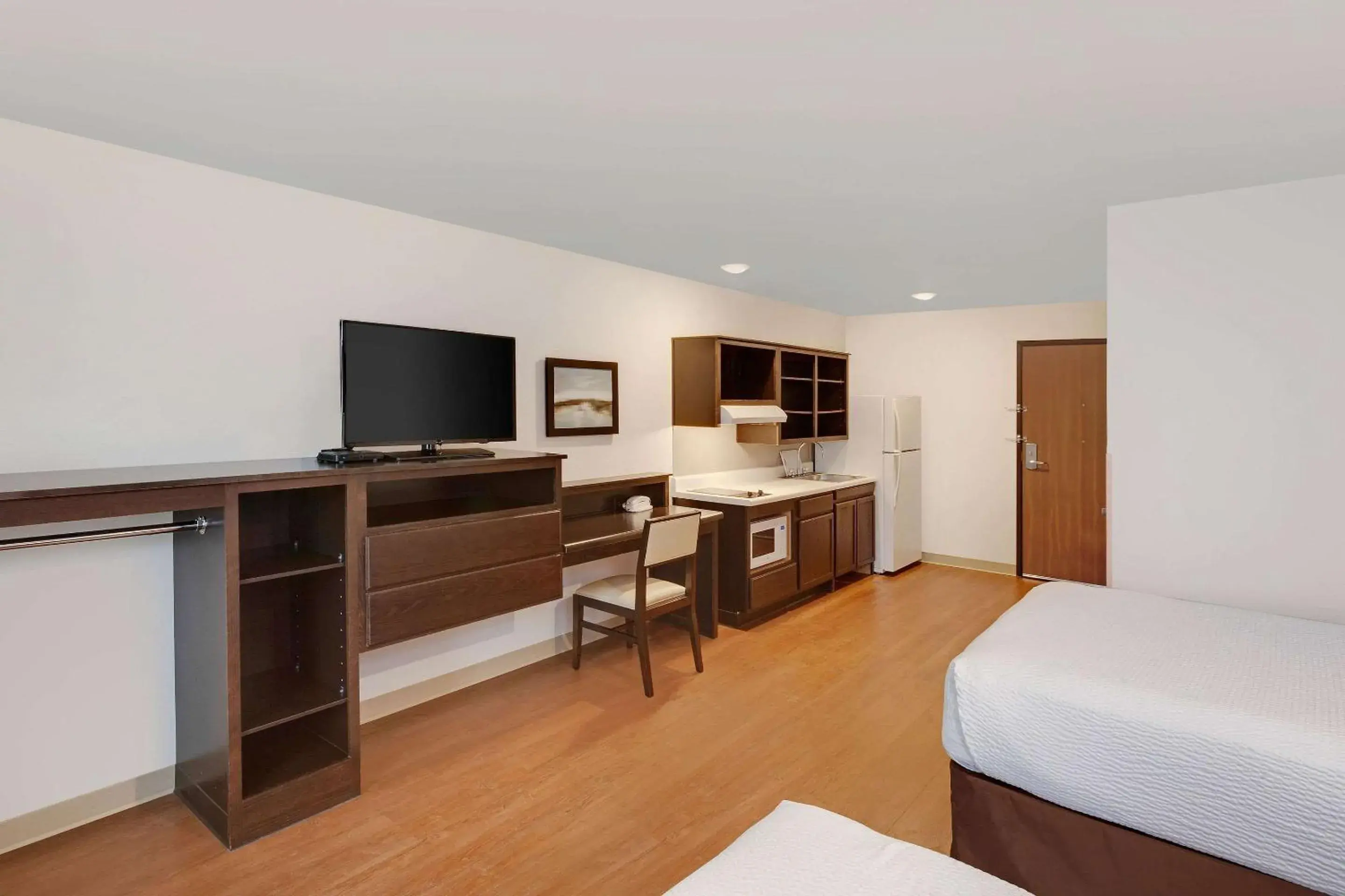 Photo of the whole room, TV/Entertainment Center in WoodSpring Suites Las Colinas