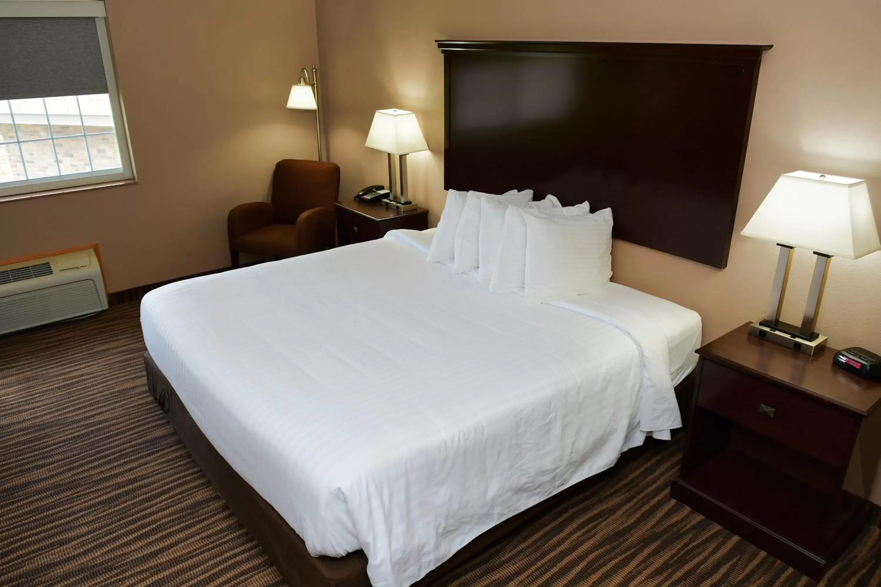 Bed in Cobblestone Inn & Suites - Denison | Majestic Hills