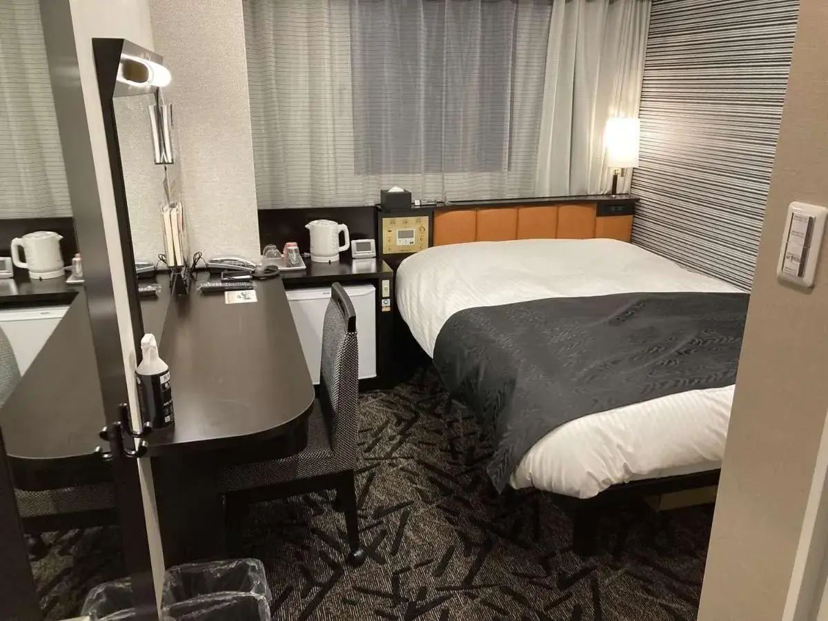 Bed in APA Hotel Beppu Ekimae Bed in APA Hotel Beppu Ekimae