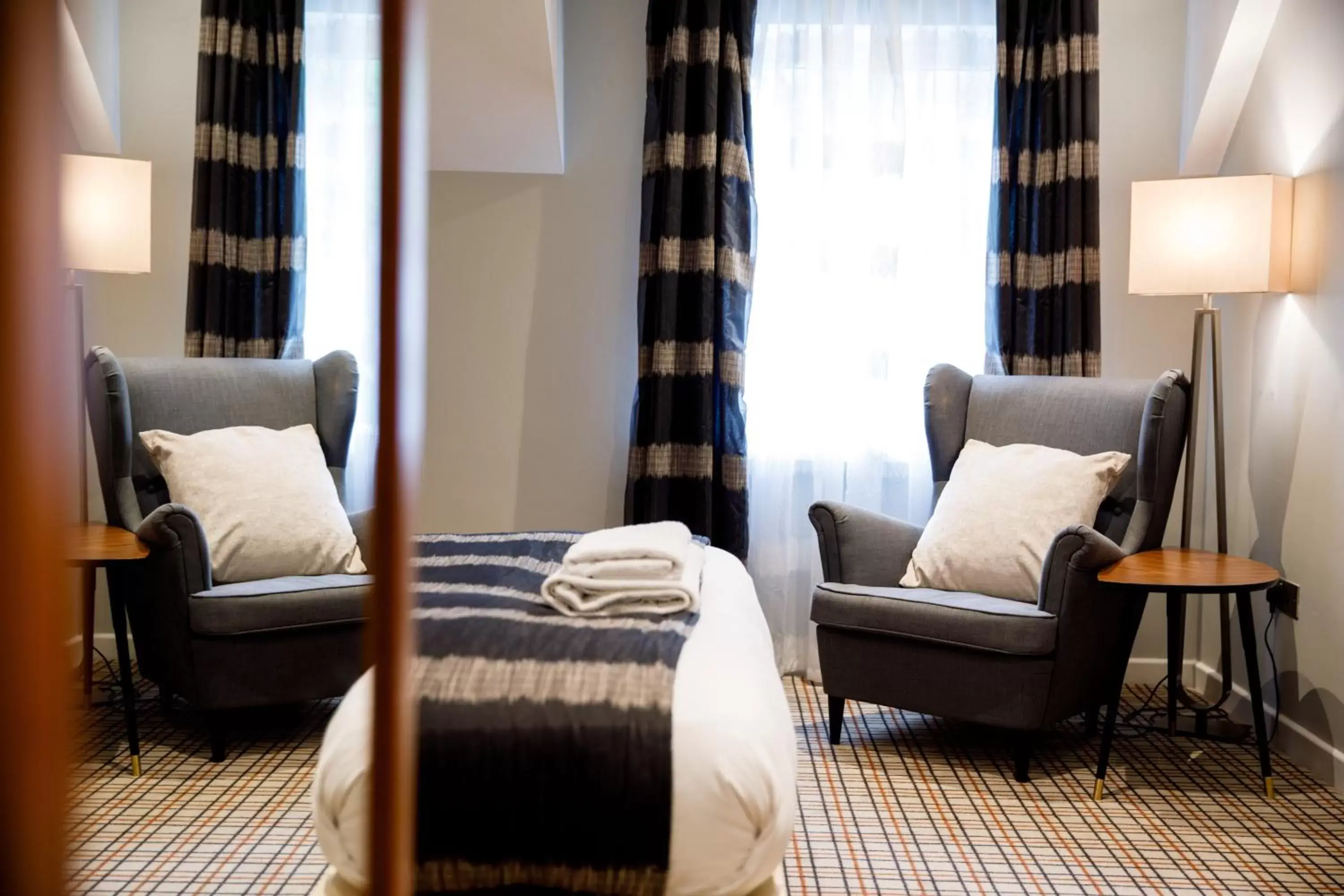 Bed, Seating Area in The Heritage Park Hotel