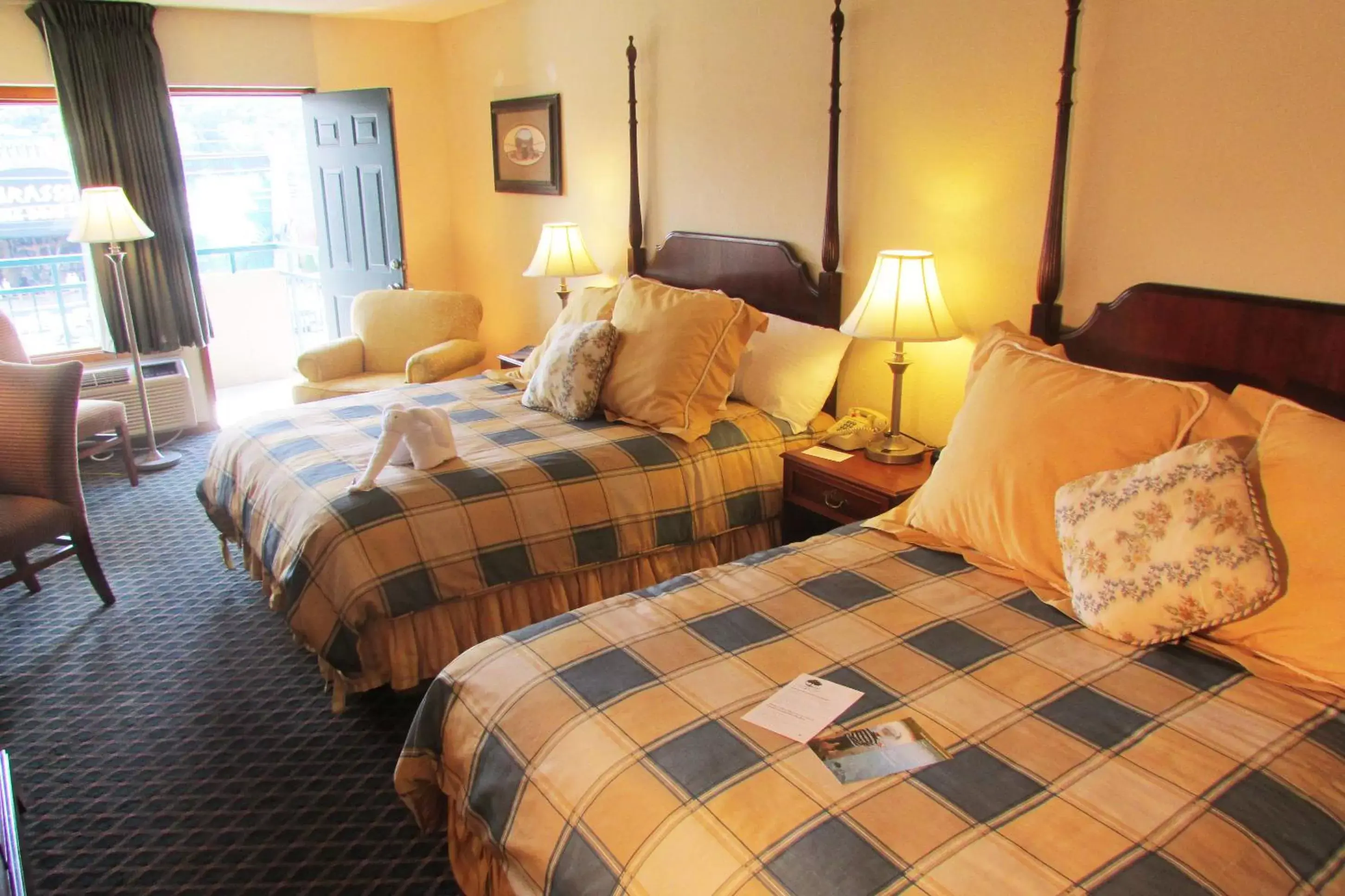 Superior Double Queen Room with Parkway View Shared Balcony with Rocking Chairs in Arbors at Island Landing Hotel & Suites Superior Double Queen Room with Parkway View Shared Balcony with Rocking Chairs in Arbors at Island Landing Hotel & Suites