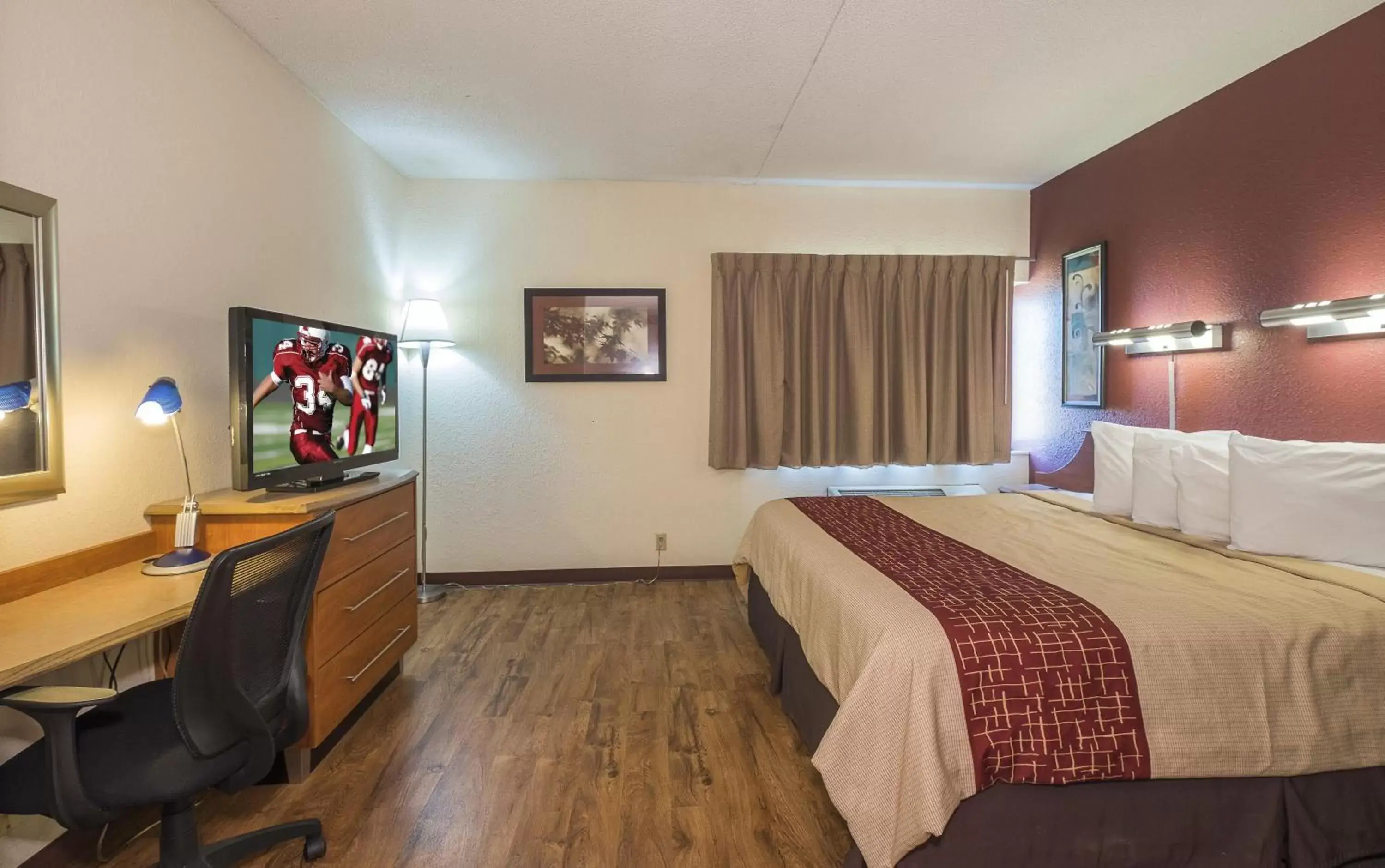 Photo of the whole room, TV/Entertainment Center in Red Roof Inn & Suites Cleveland - Elyria