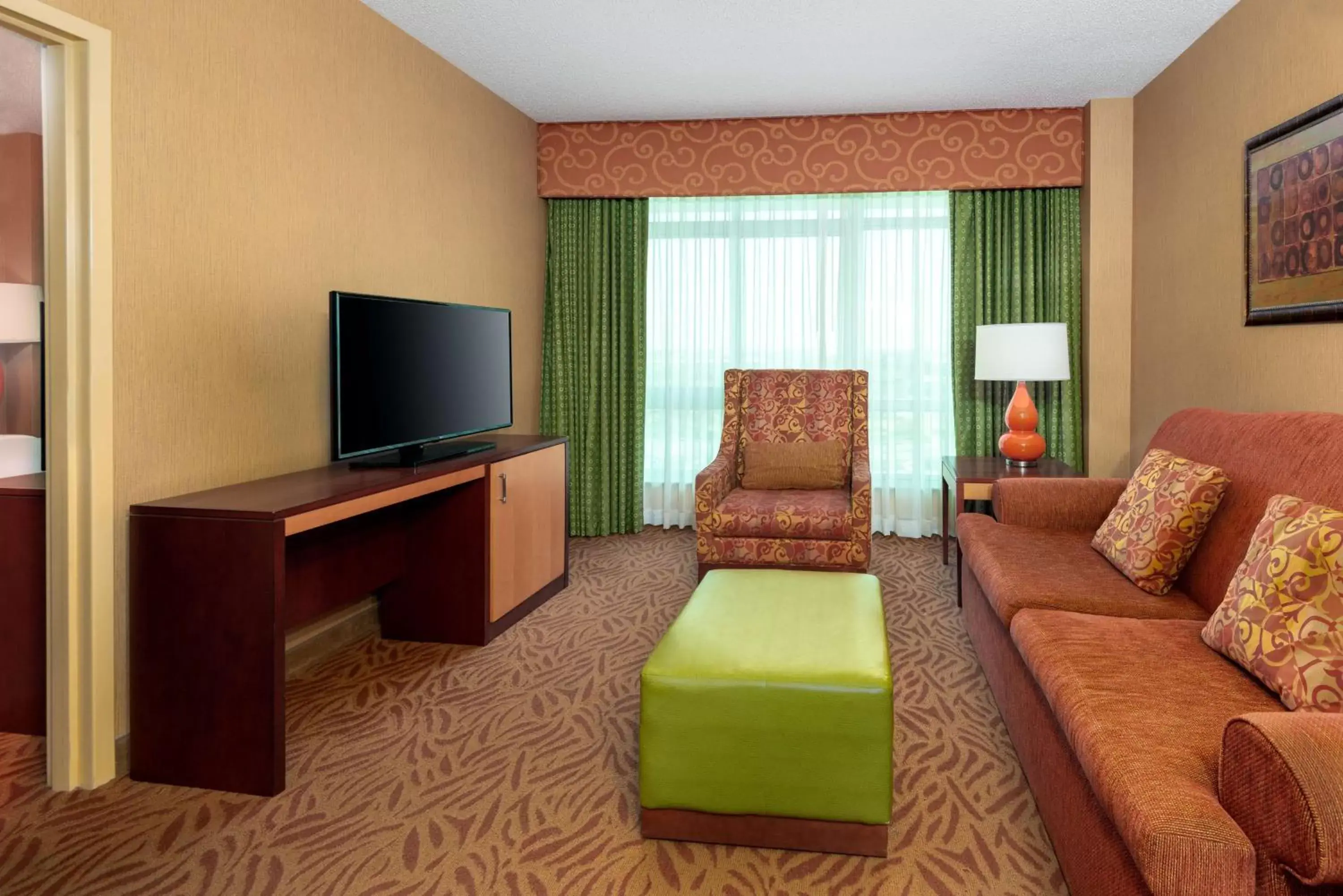 Bedroom, TV/Entertainment Center in Embassy Suites Omaha- La Vista/ Hotel & Conference Center