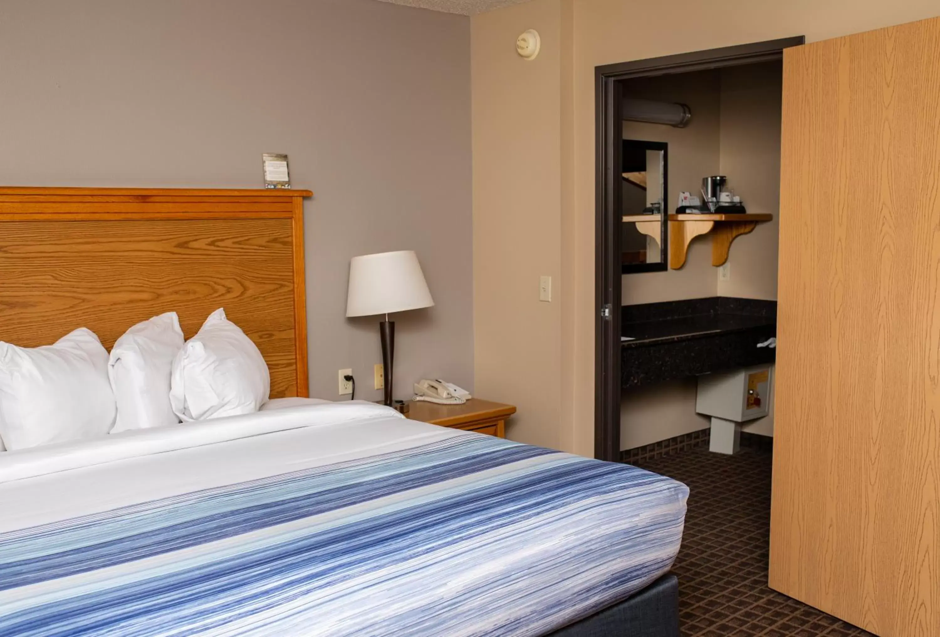 Bed in AmericInn by Wyndham Aberdeen Event Center