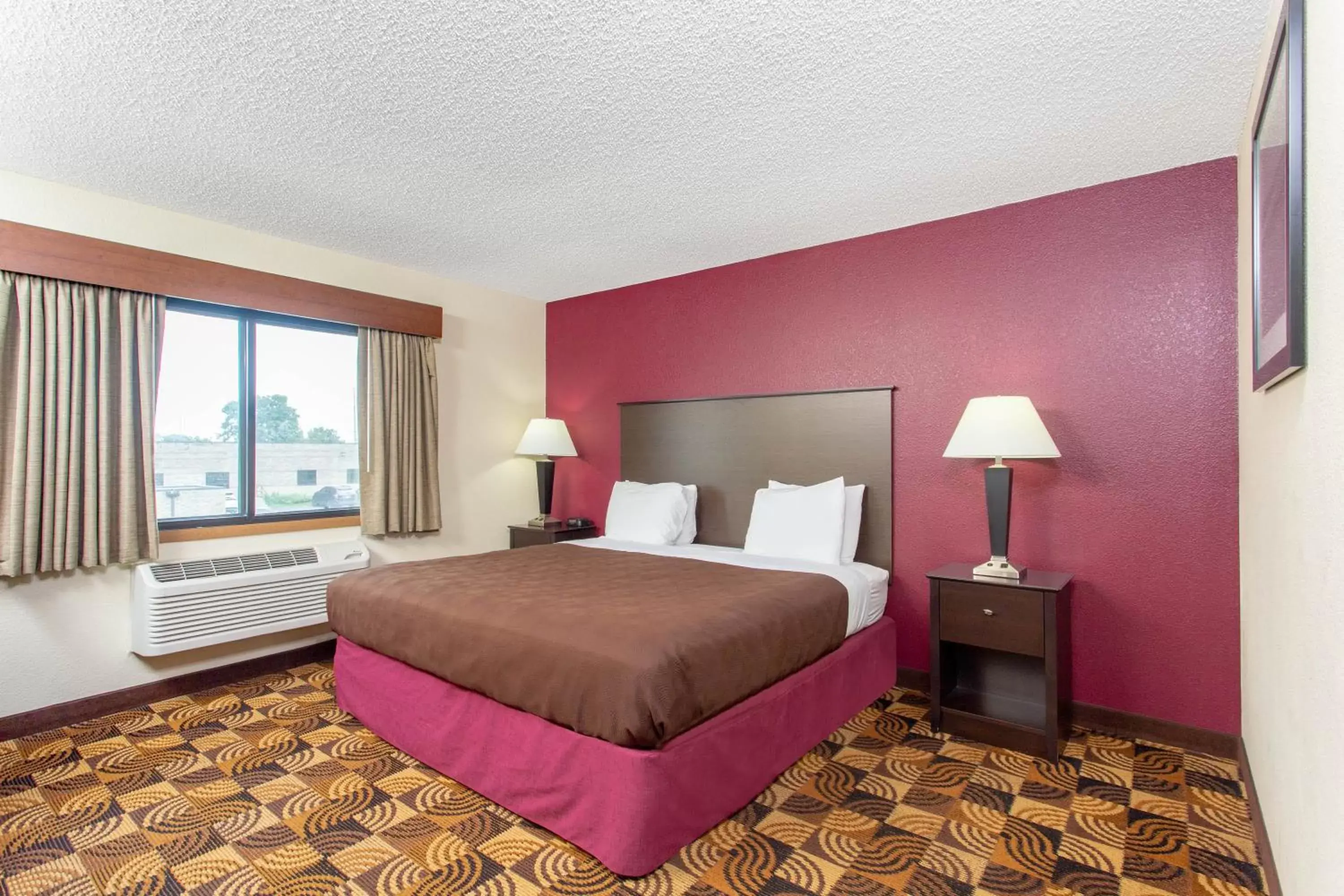 Bed in AmericInn by Wyndham Elkhorn Near Lake Geneva