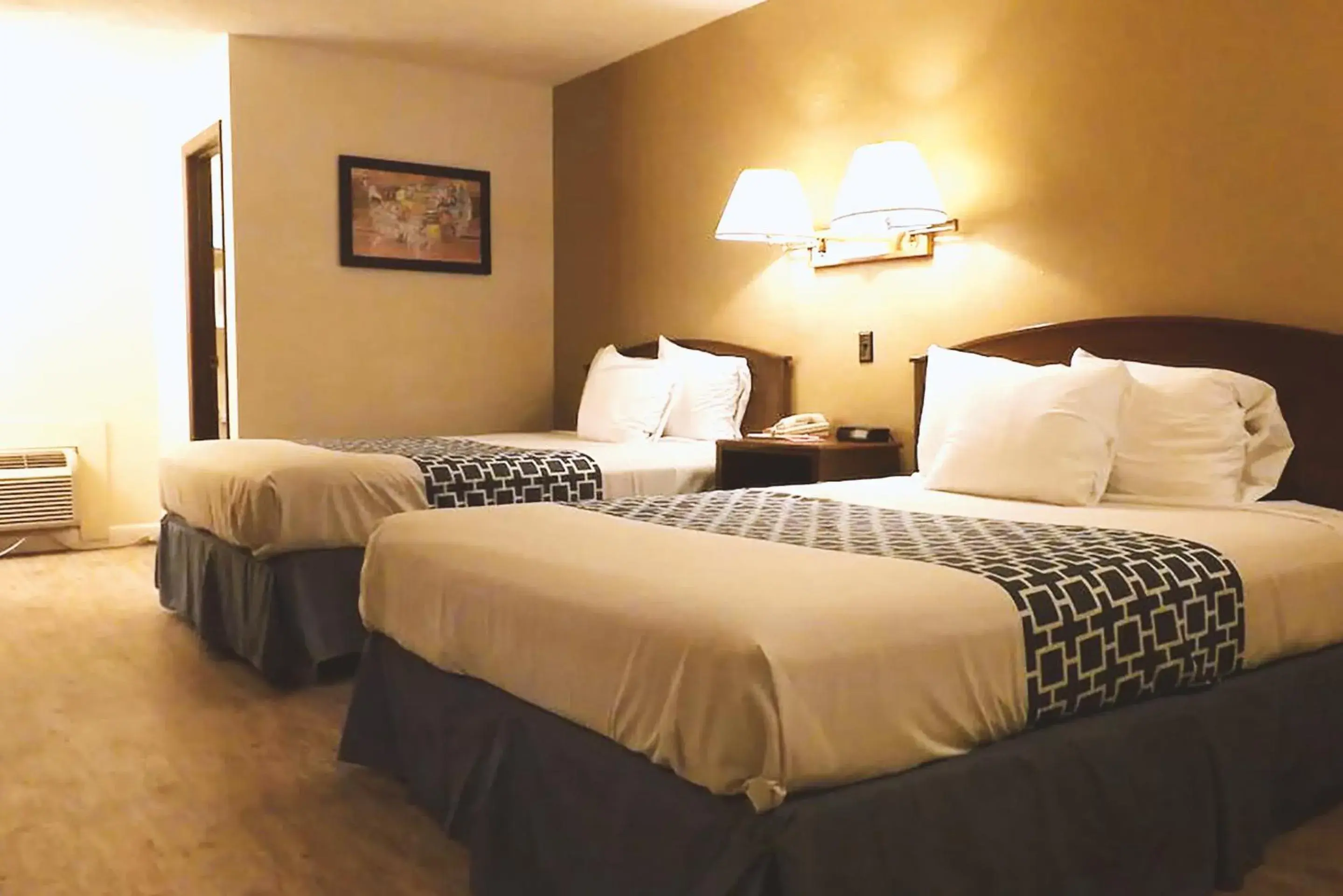 Bed in Coratel Inn & Suites by Jasper McCook