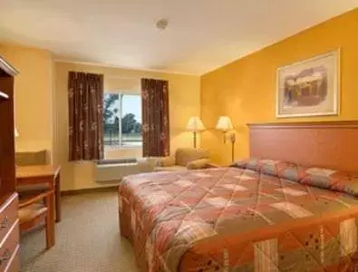 Bed in Super 8 by Wyndham Topeka at Forbes Landing