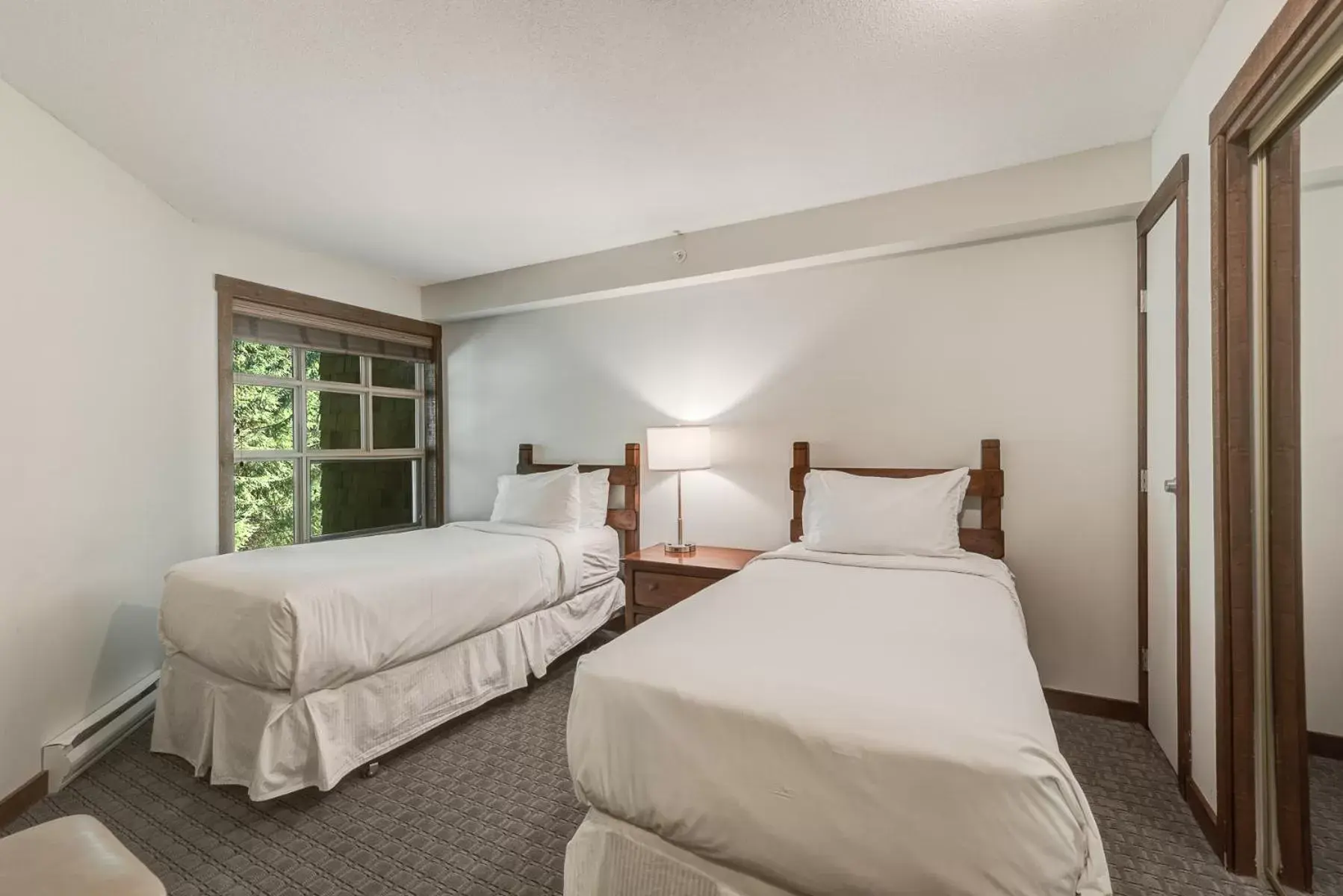 Bed in Blackcomb Springs Suites by CLIQUE