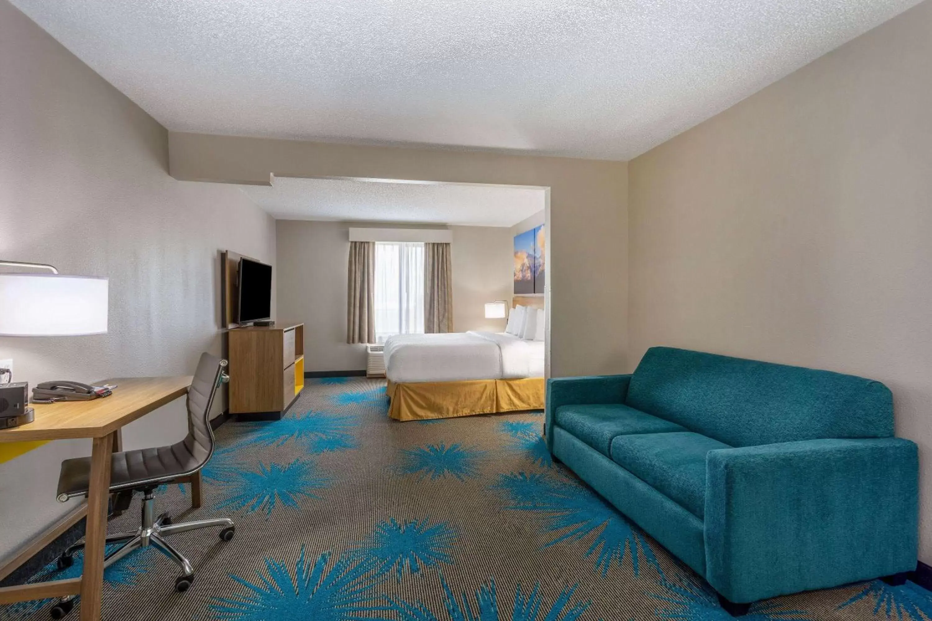 Bed, Seating Area in Days Inn & Suites by Wyndham Denver International Airport