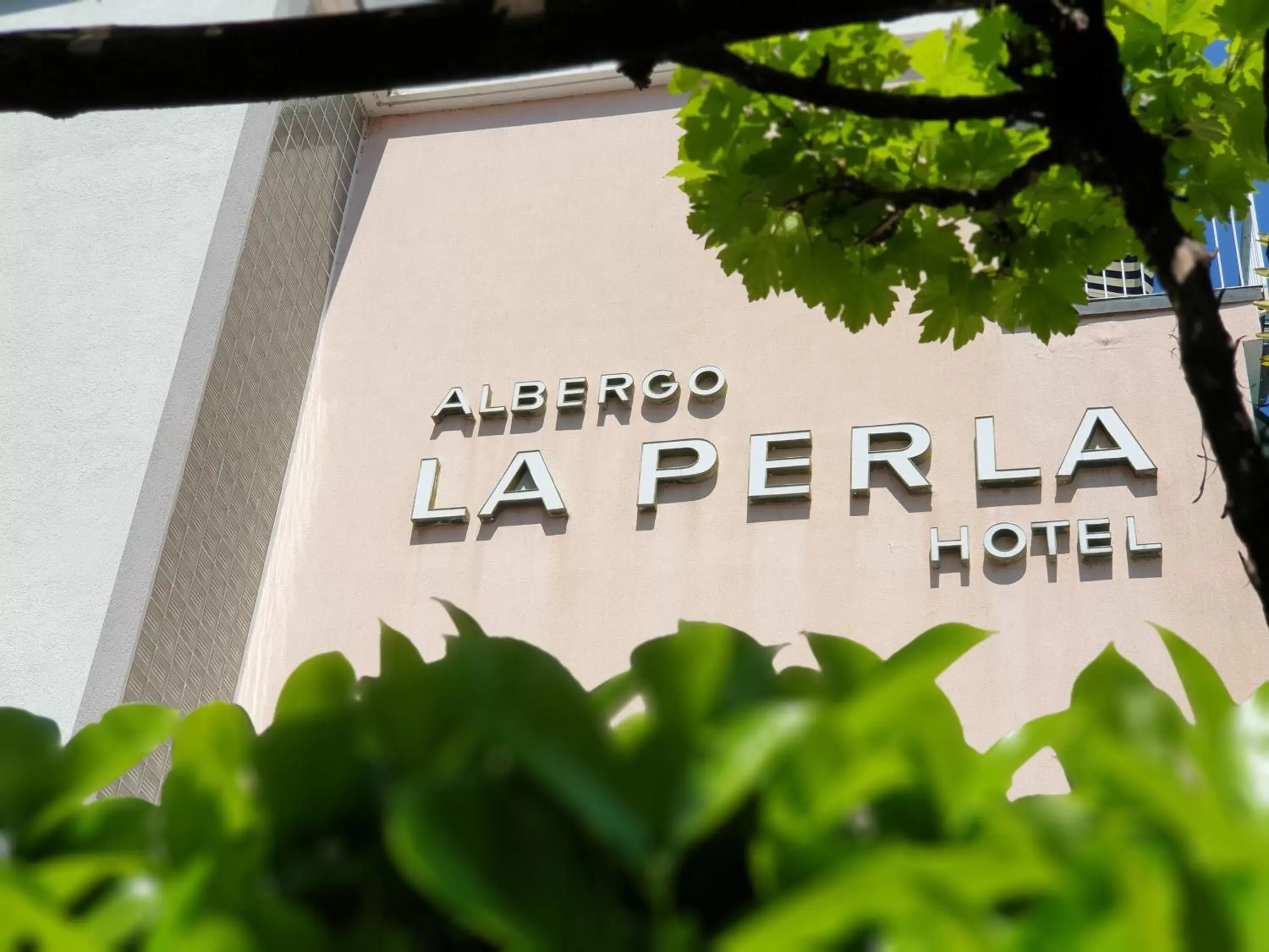 Property building, Property Logo/Sign in Hotel La Perla