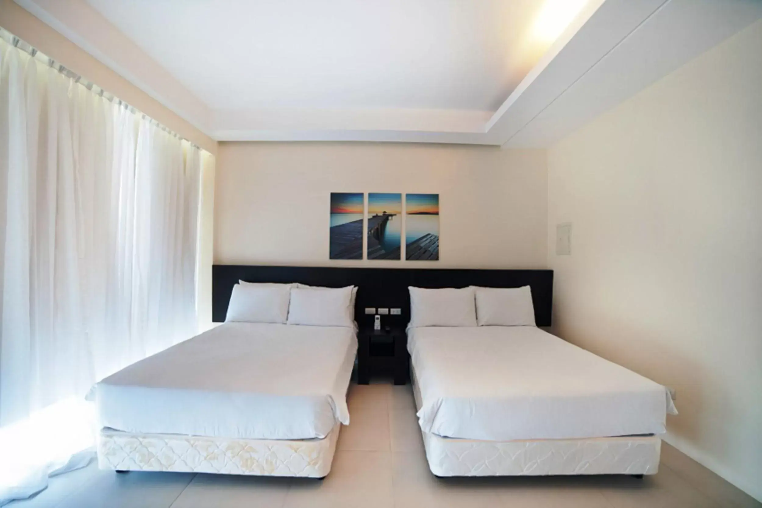 Photo of the whole room, Bed in Ocean Suites Bohol Boutique Hotel