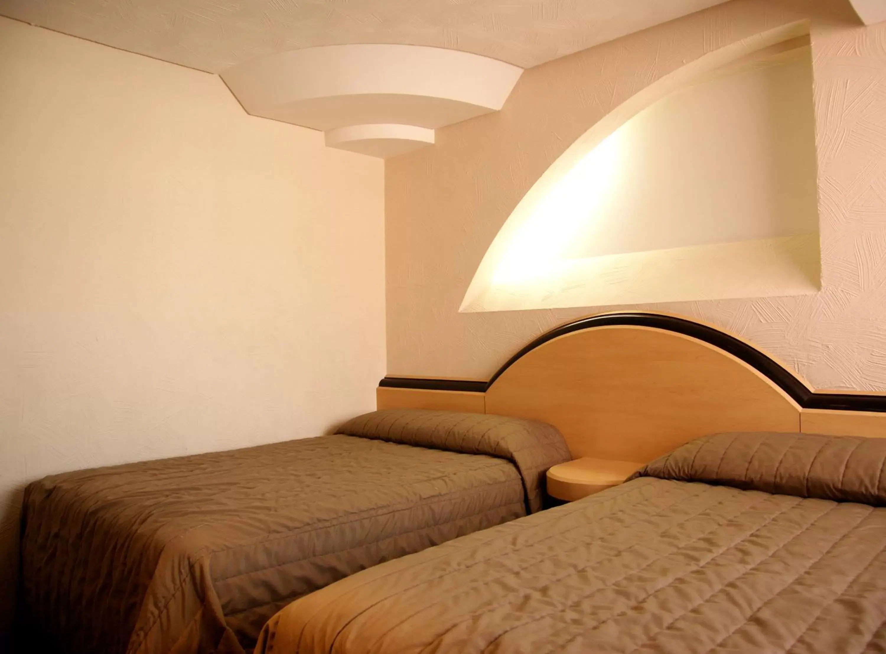 Bed in Porto Novo Hotel & Suites