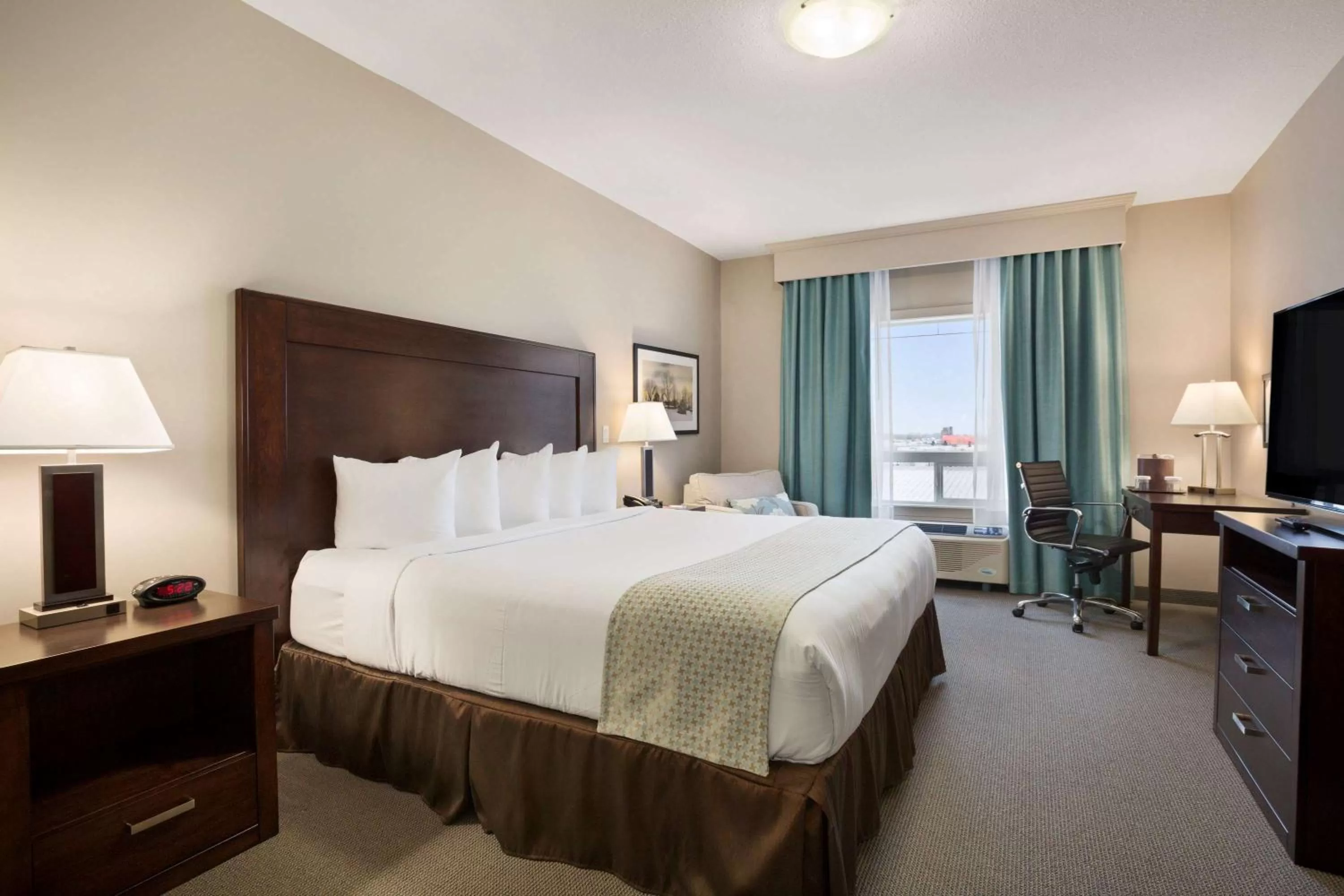 Photo of the whole room, Bed in Ramada by Wyndham Emerald Park/Regina East