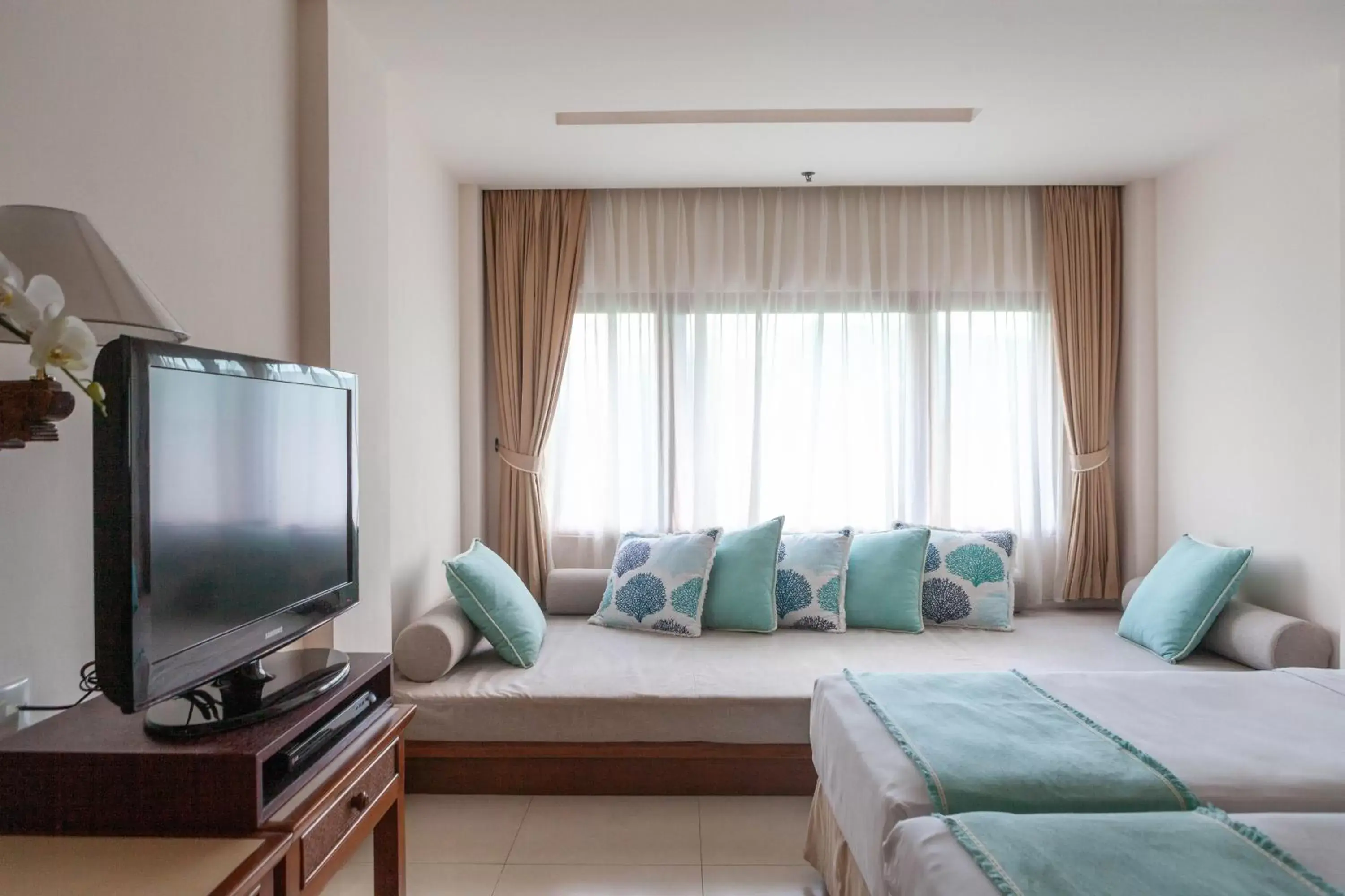 Bed, TV/Entertainment Center in Bali Mandira Beach Resort & Spa