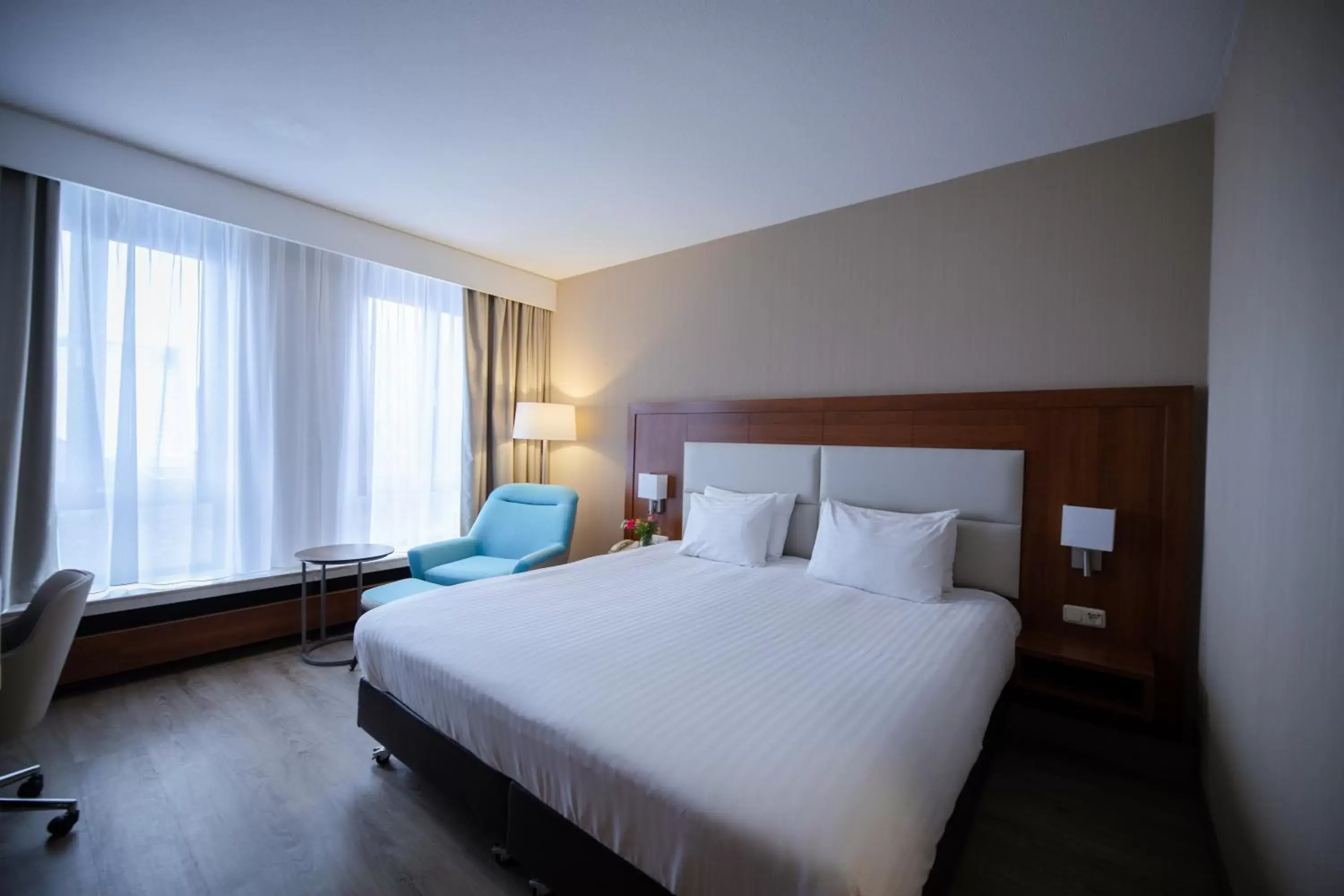 Bed in Crowne Plaza Maastricht, an IHG Hotel