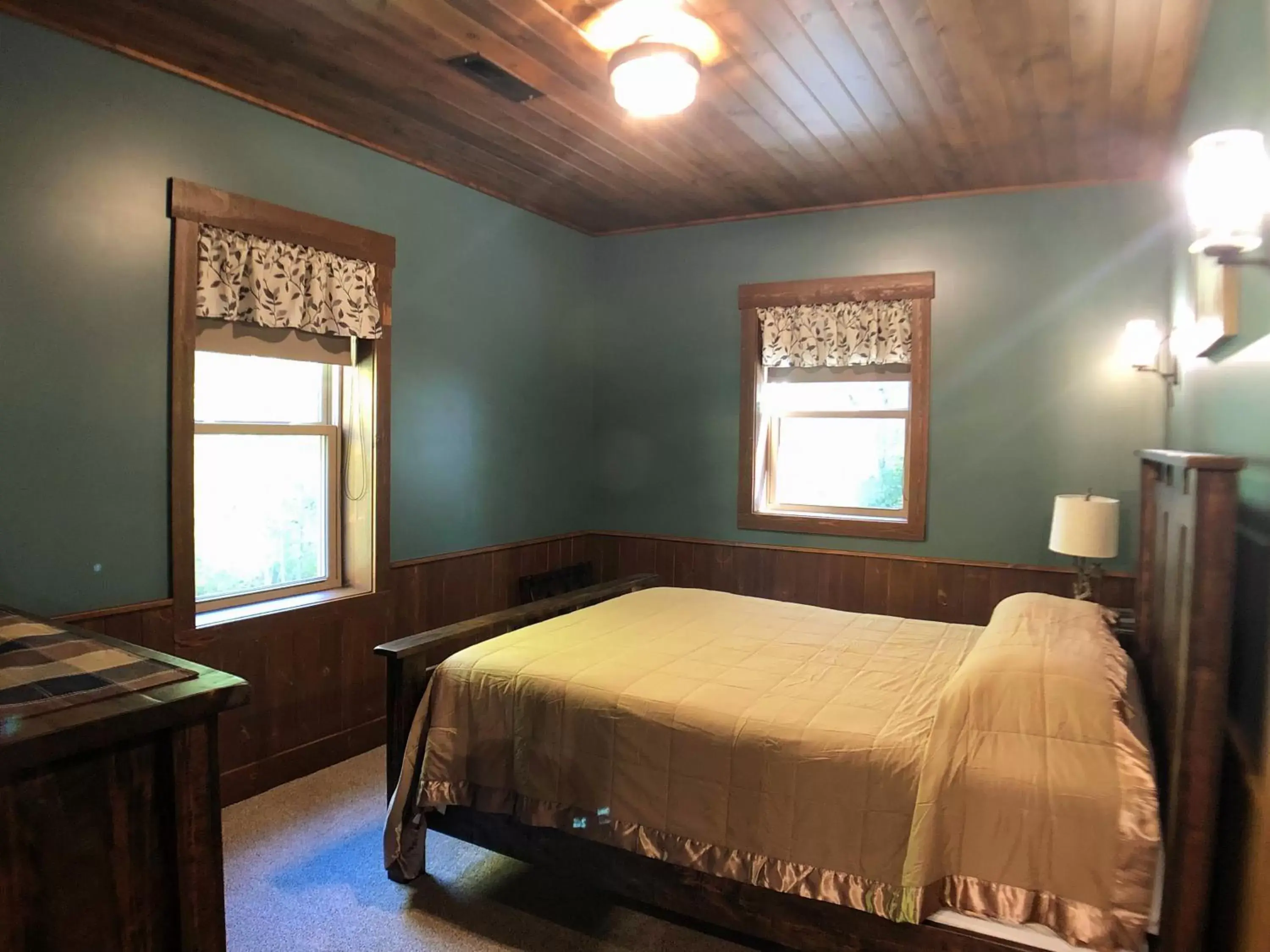 Bed in Sojourner's Lodge & Log Cabin Suites