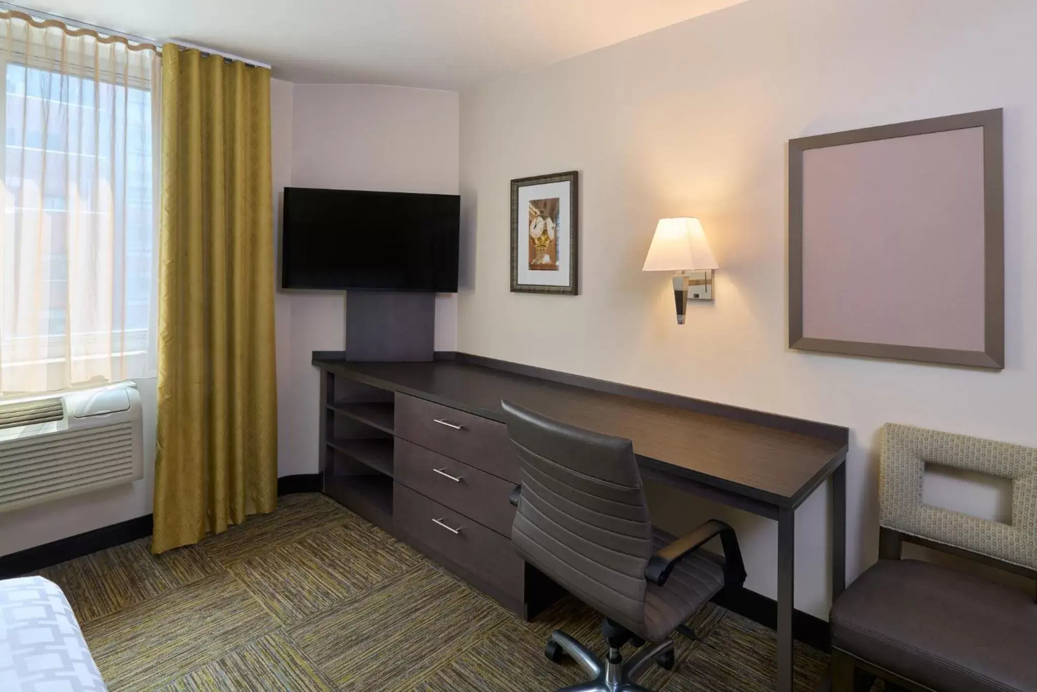 Photo of the whole room, TV/Entertainment Center in Candlewood Suites NYC -Times Square, an IHG Hotel
