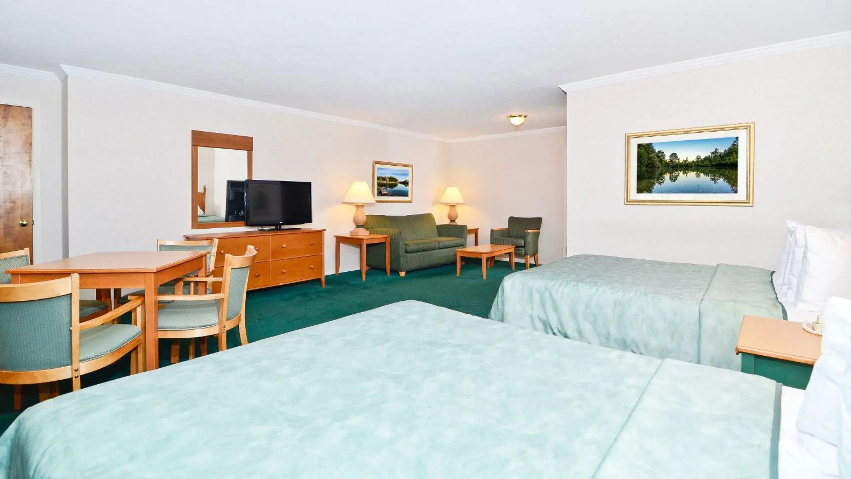 Photo of the whole room, TV/Entertainment Center in Magnuson Grand Pioneer Inn And Suites