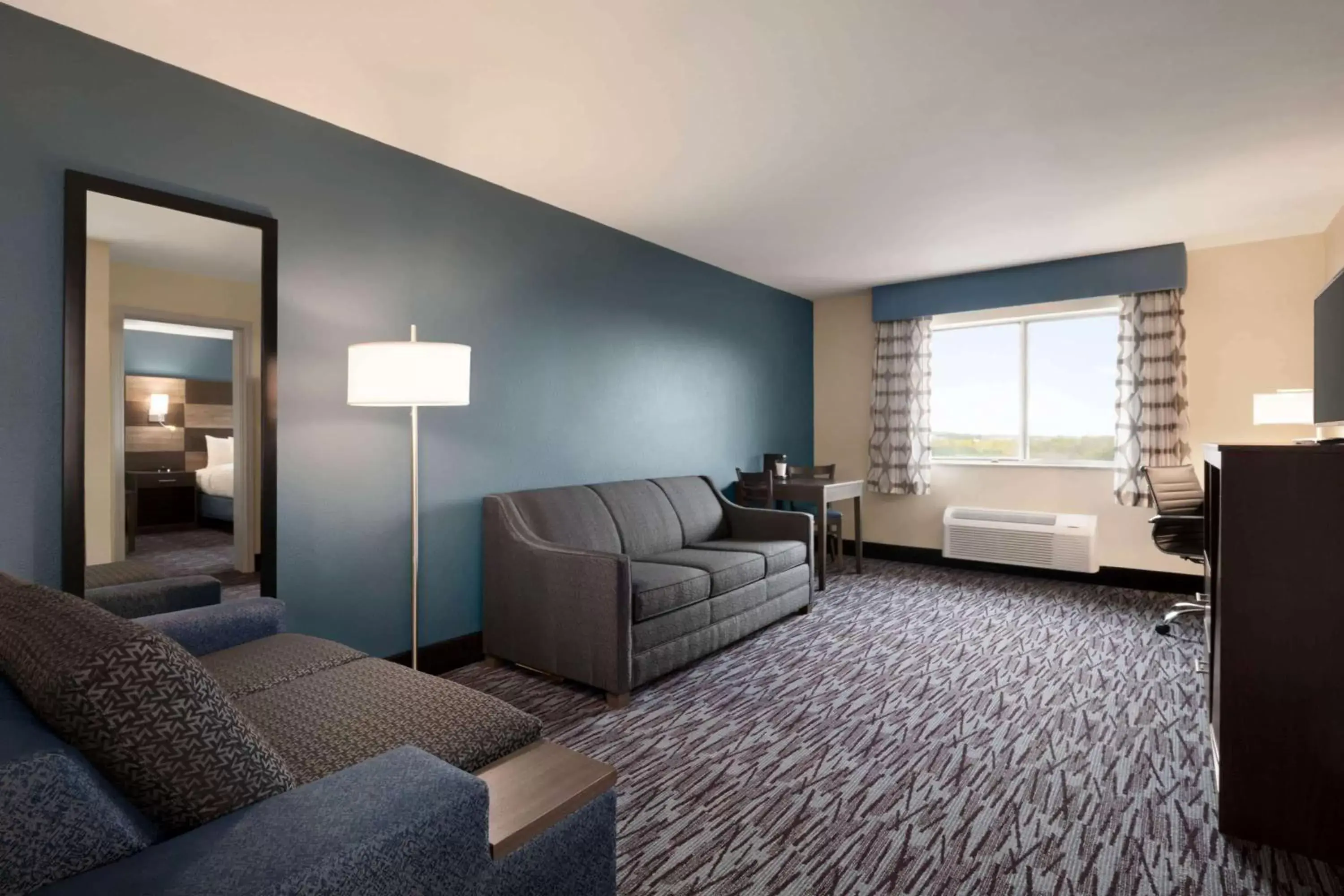 Bed, Seating Area in AmericInn by Wyndham Dodgeville