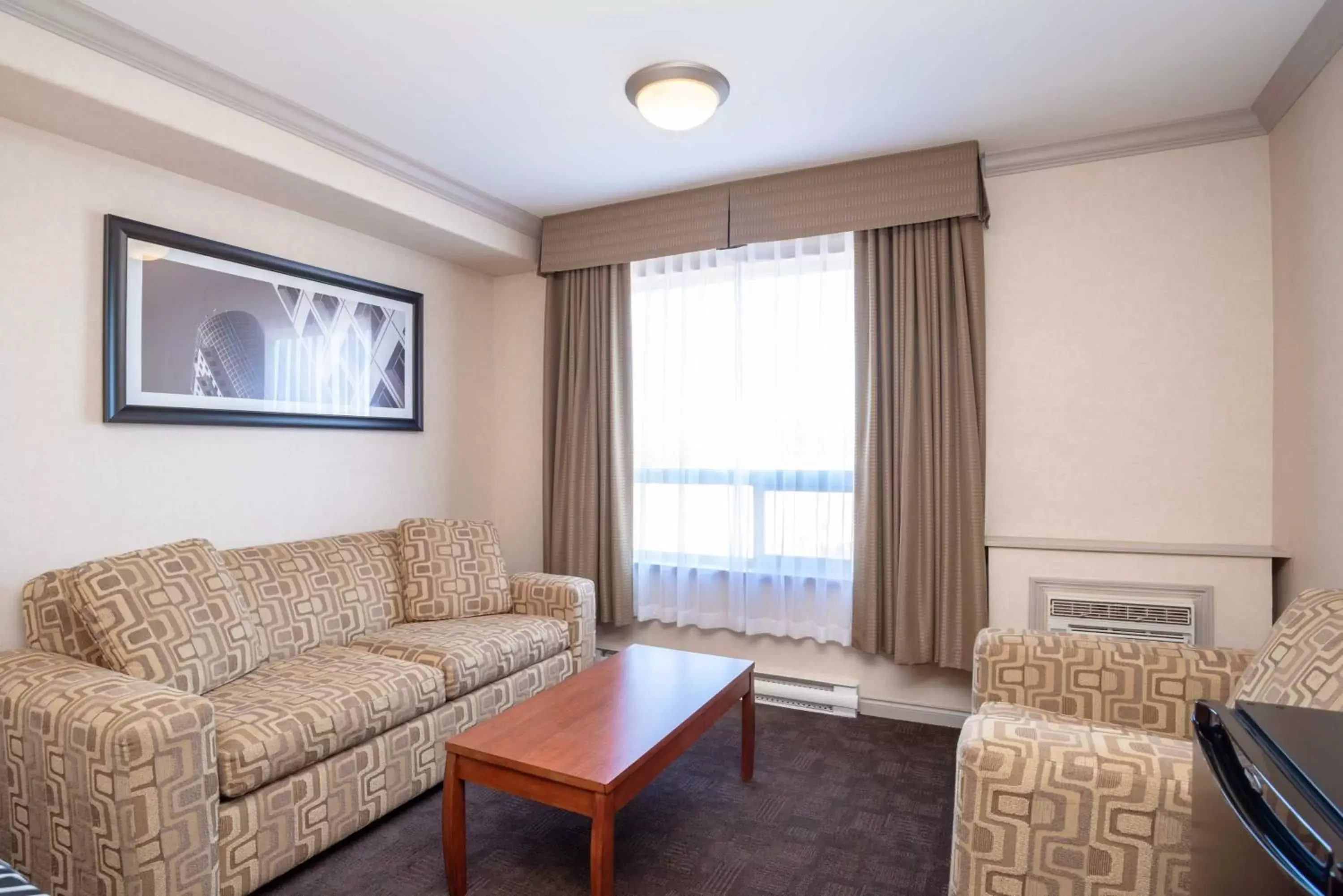 Photo of the whole room, Seating Area in Sandman Hotel & Suites Winnipeg Airport
