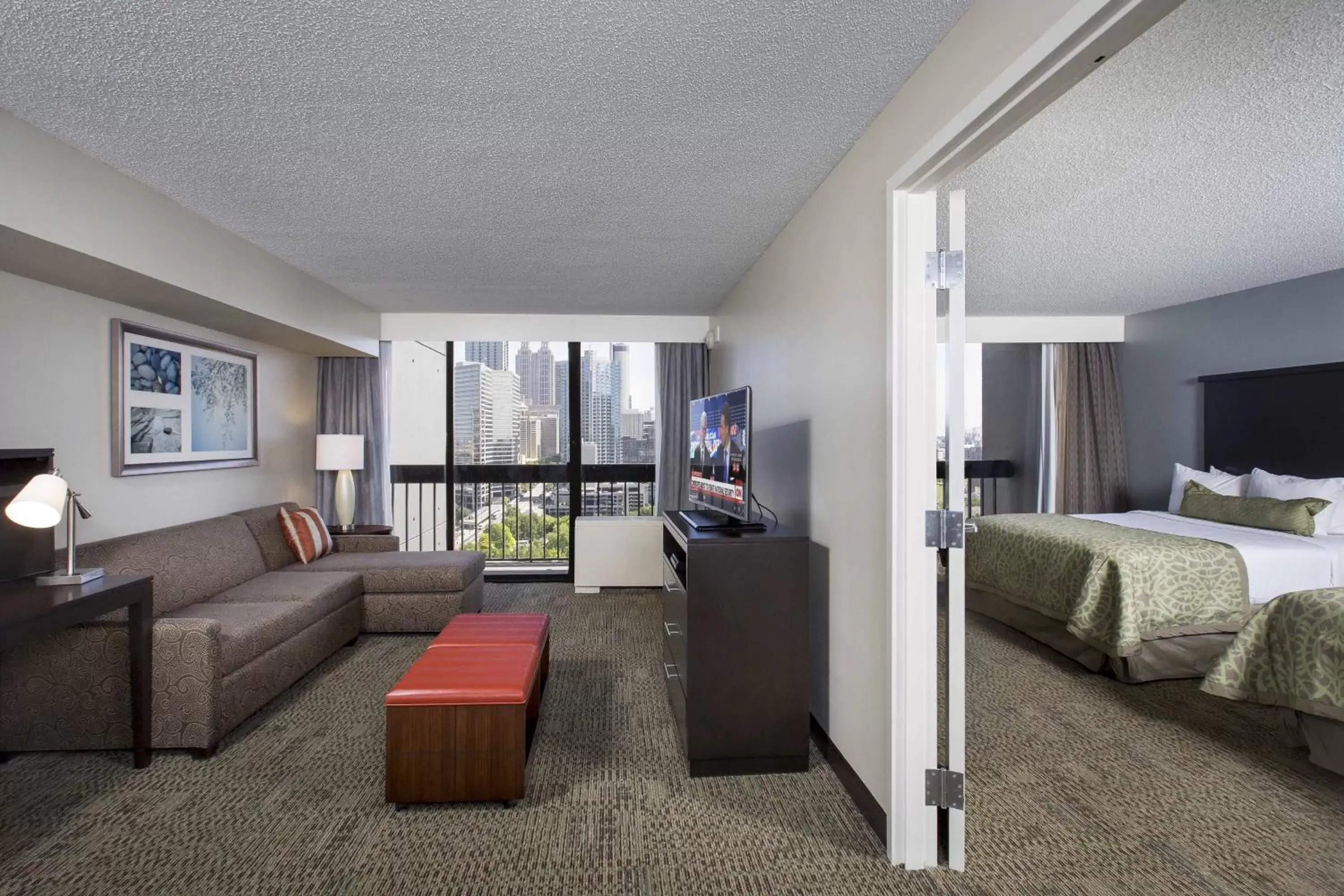 Bedroom, Seating Area in Staybridge Suites Atlanta - Midtown, an IHG Hotel