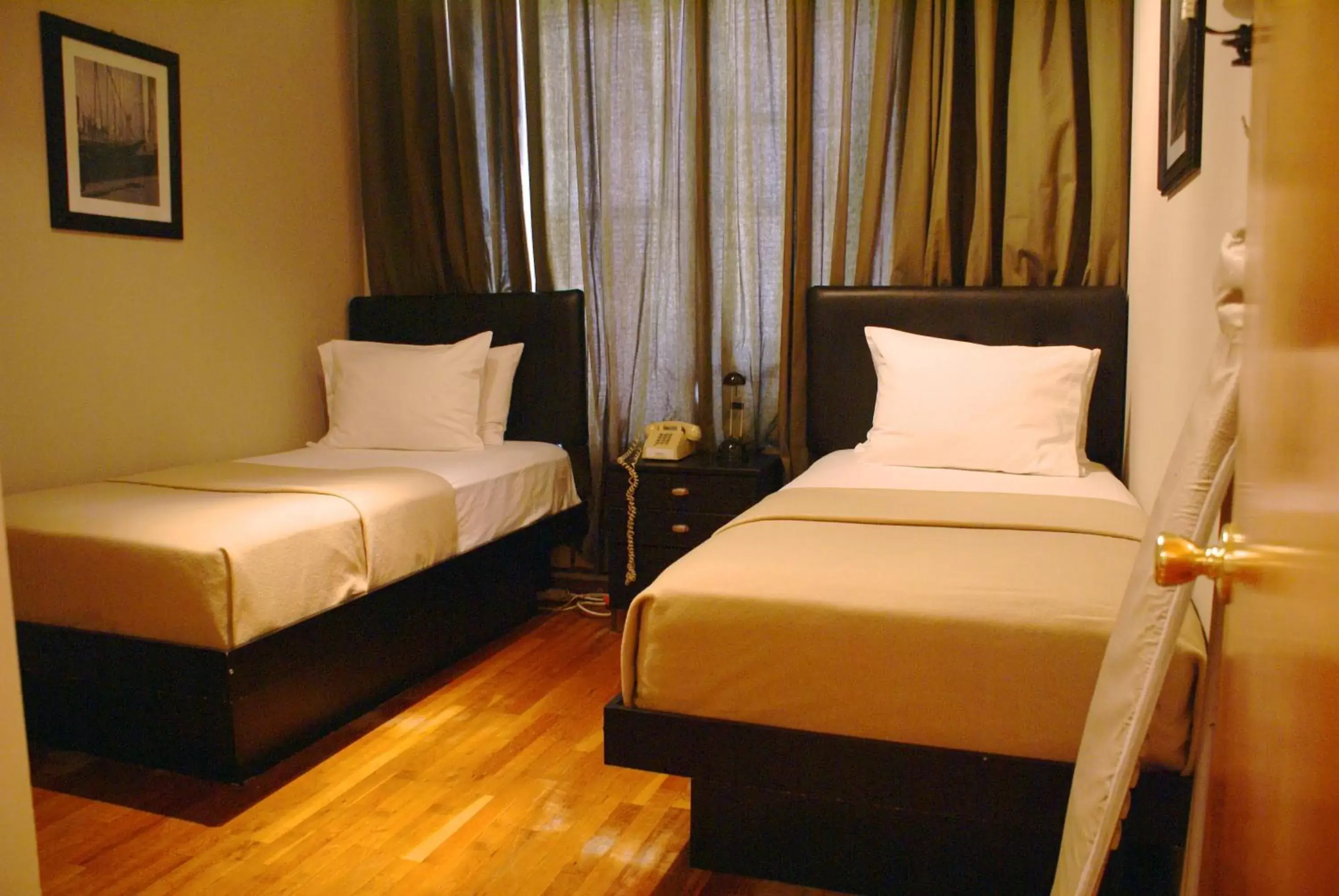 Bed in Off Soho Suites Hotel
