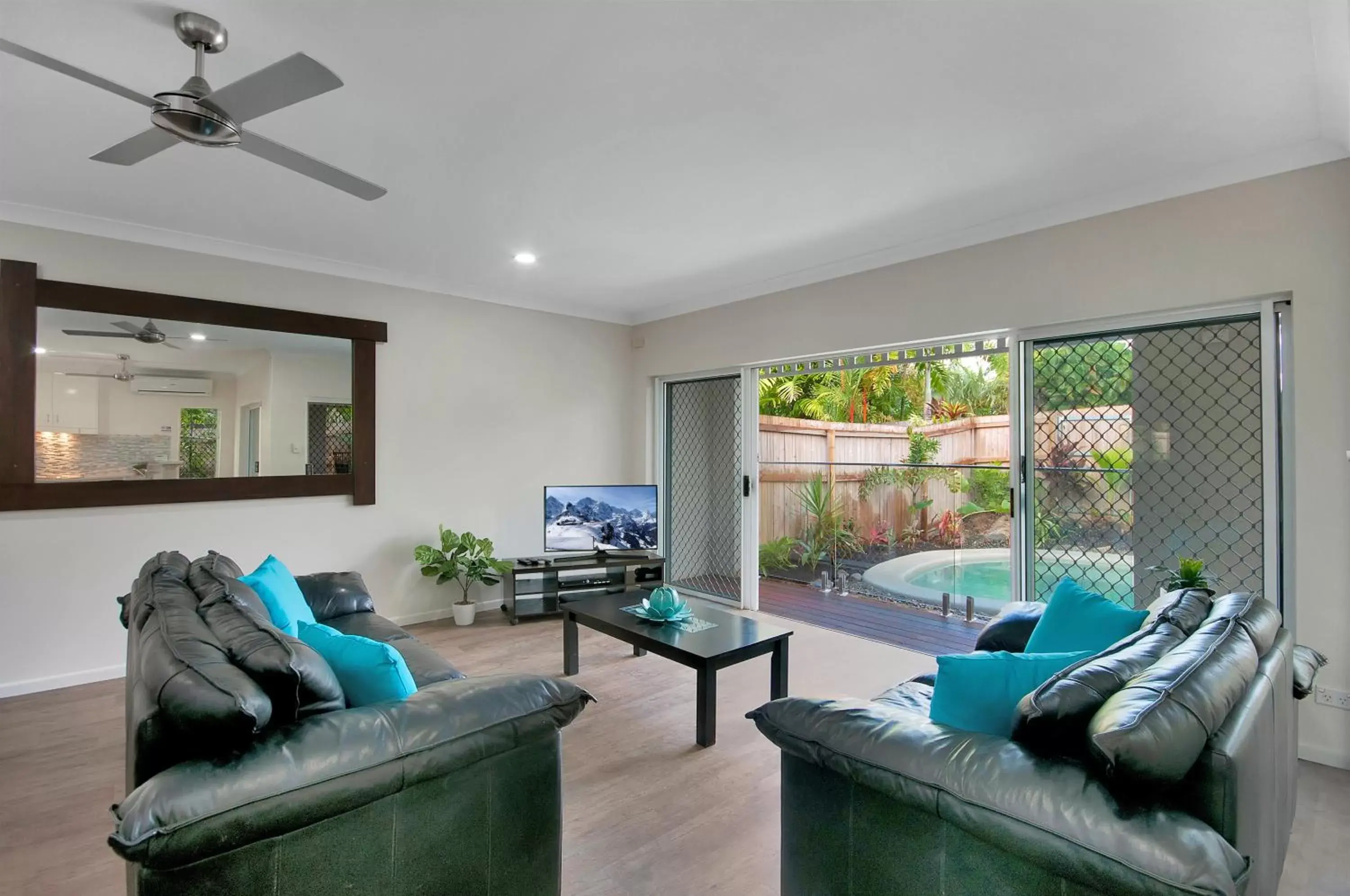 Communal lounge/ TV room, Seating Area in The Villas Palm Cove