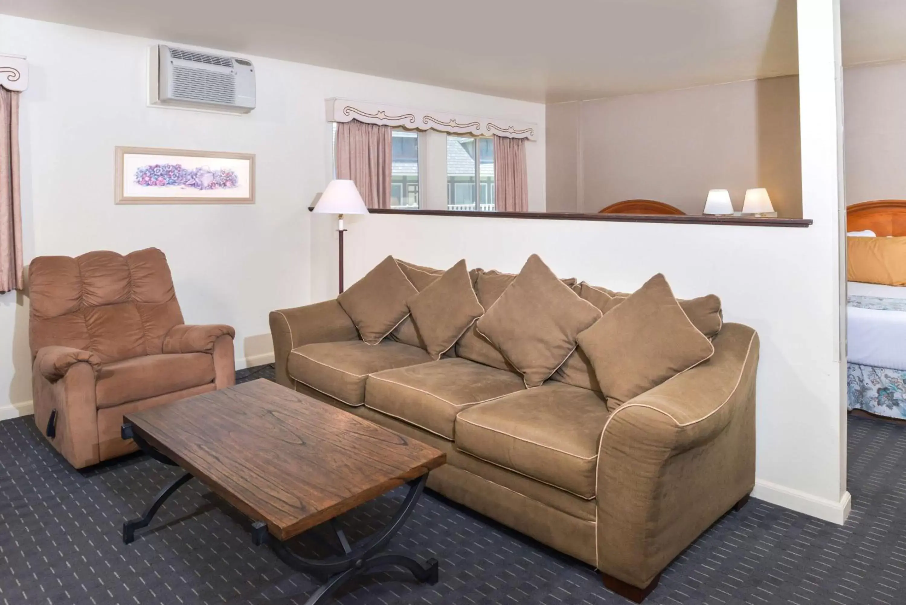 Bedroom, Seating Area in Svendsgaard's Lodge- Americas Best Value Inn & Suites