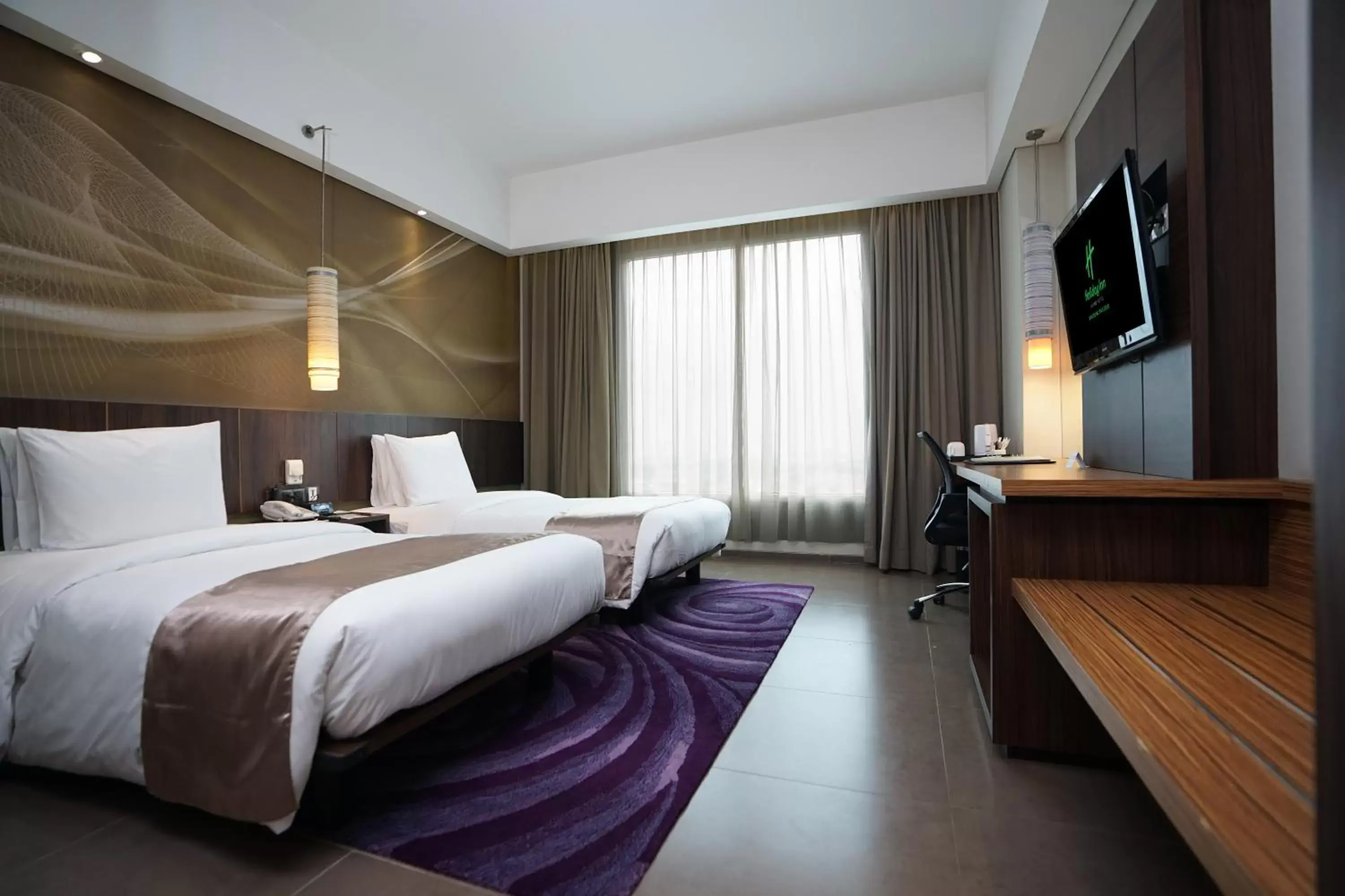 Bed in Holiday Inn Bandung Pasteur, an IHG Hotel