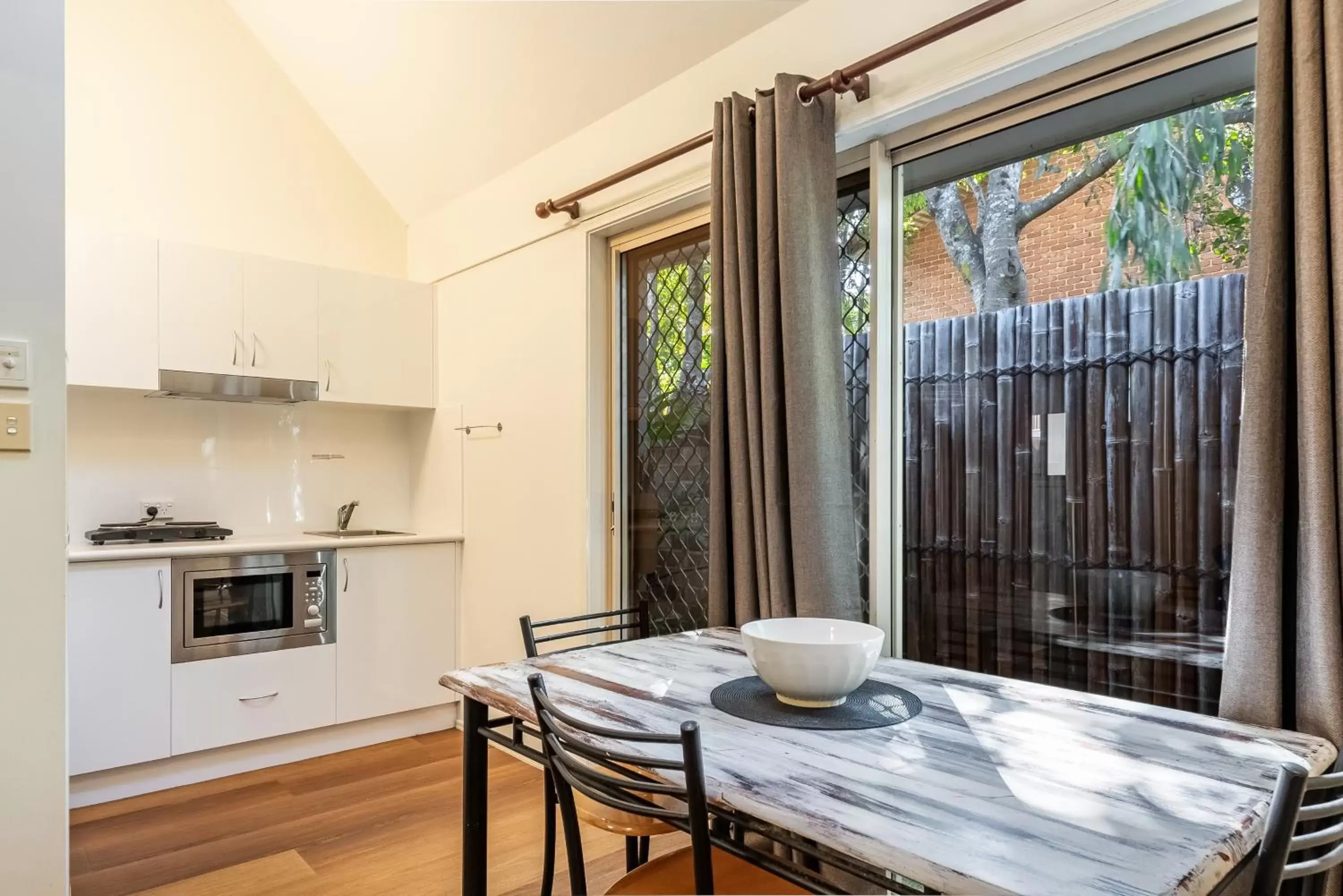 Patio, Dining Area in Byron Central Apartments