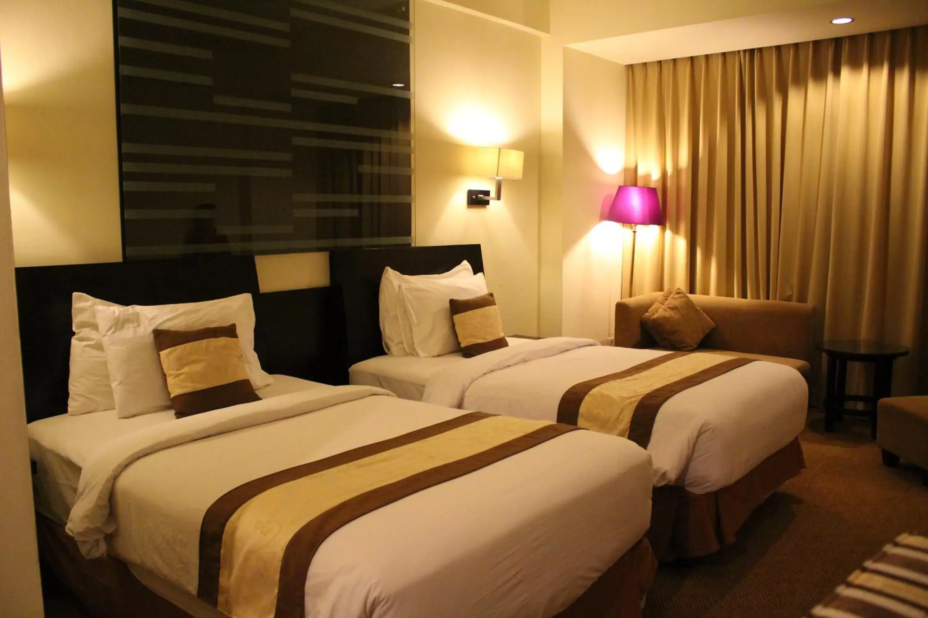 Bed in Swiss-Belhotel Silae Palu