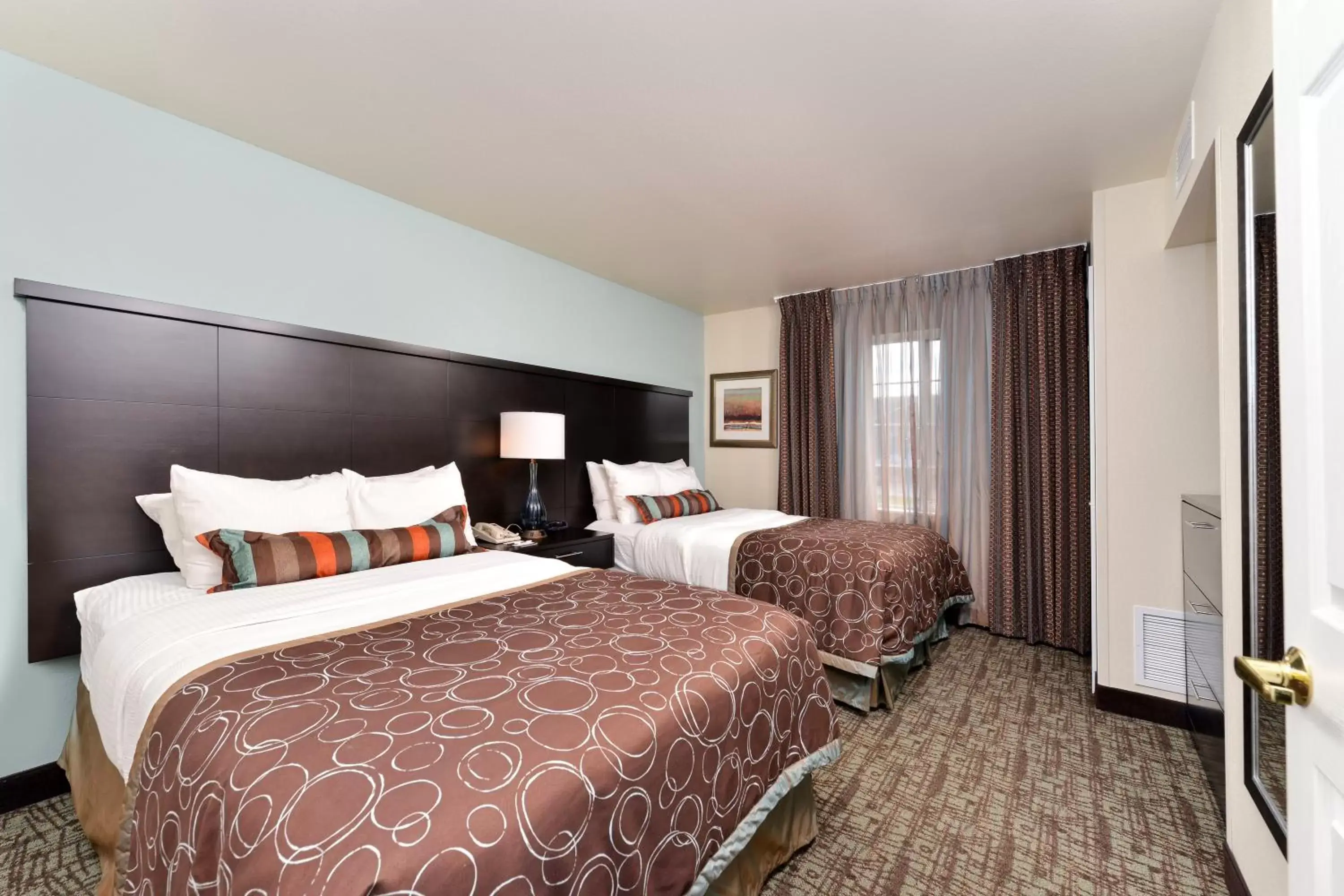 Photo of the whole room, Bed in Staybridge Suites Sioux Falls at Empire Mall, an IHG Hotel