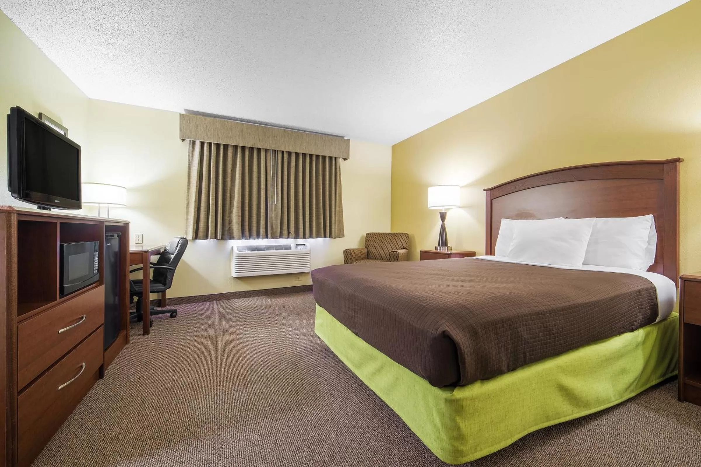 Bed in AmericInn by Wyndham Sioux Falls