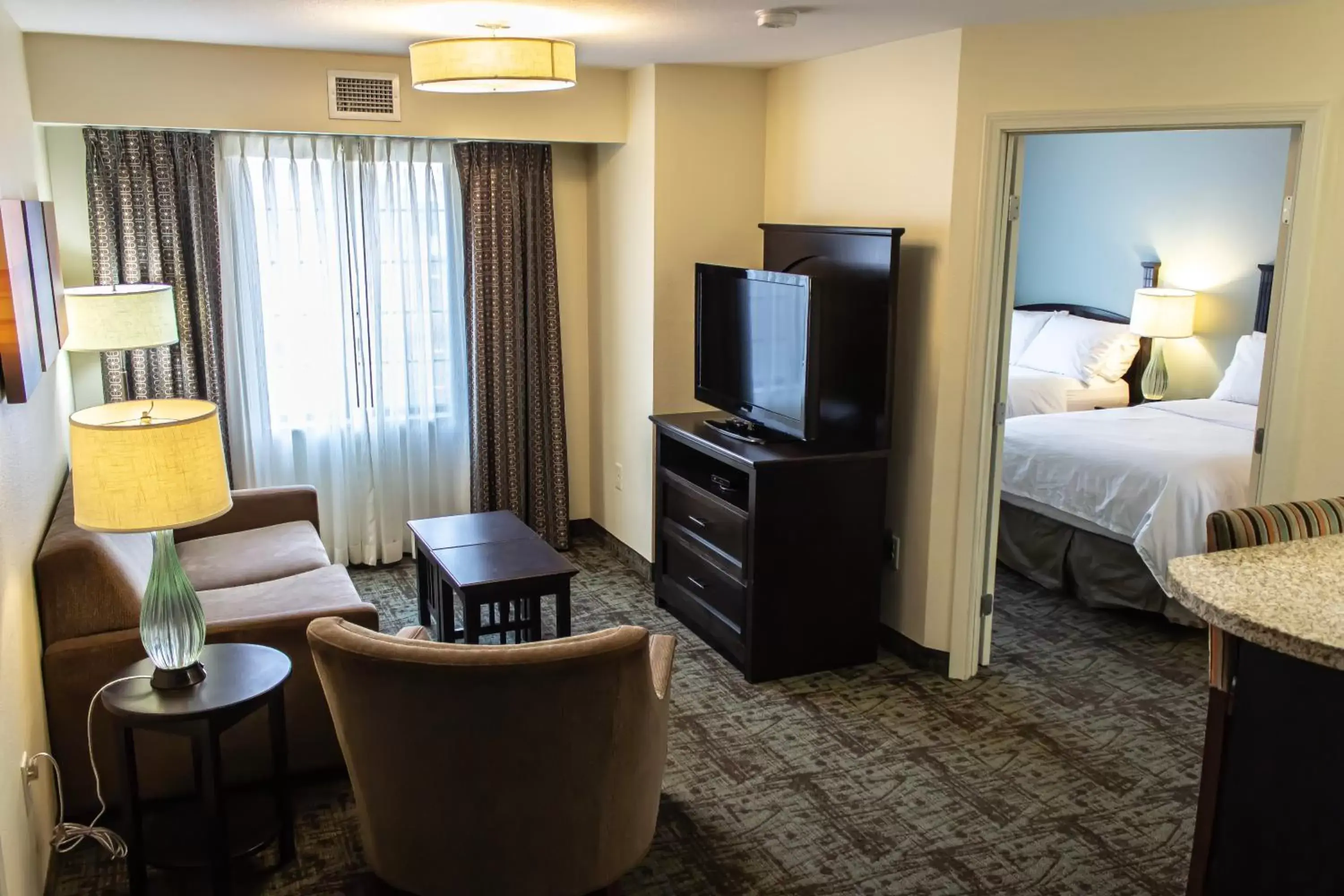 Bedroom, TV/Entertainment Center in Staybridge Suites Minot, an IHG Hotel