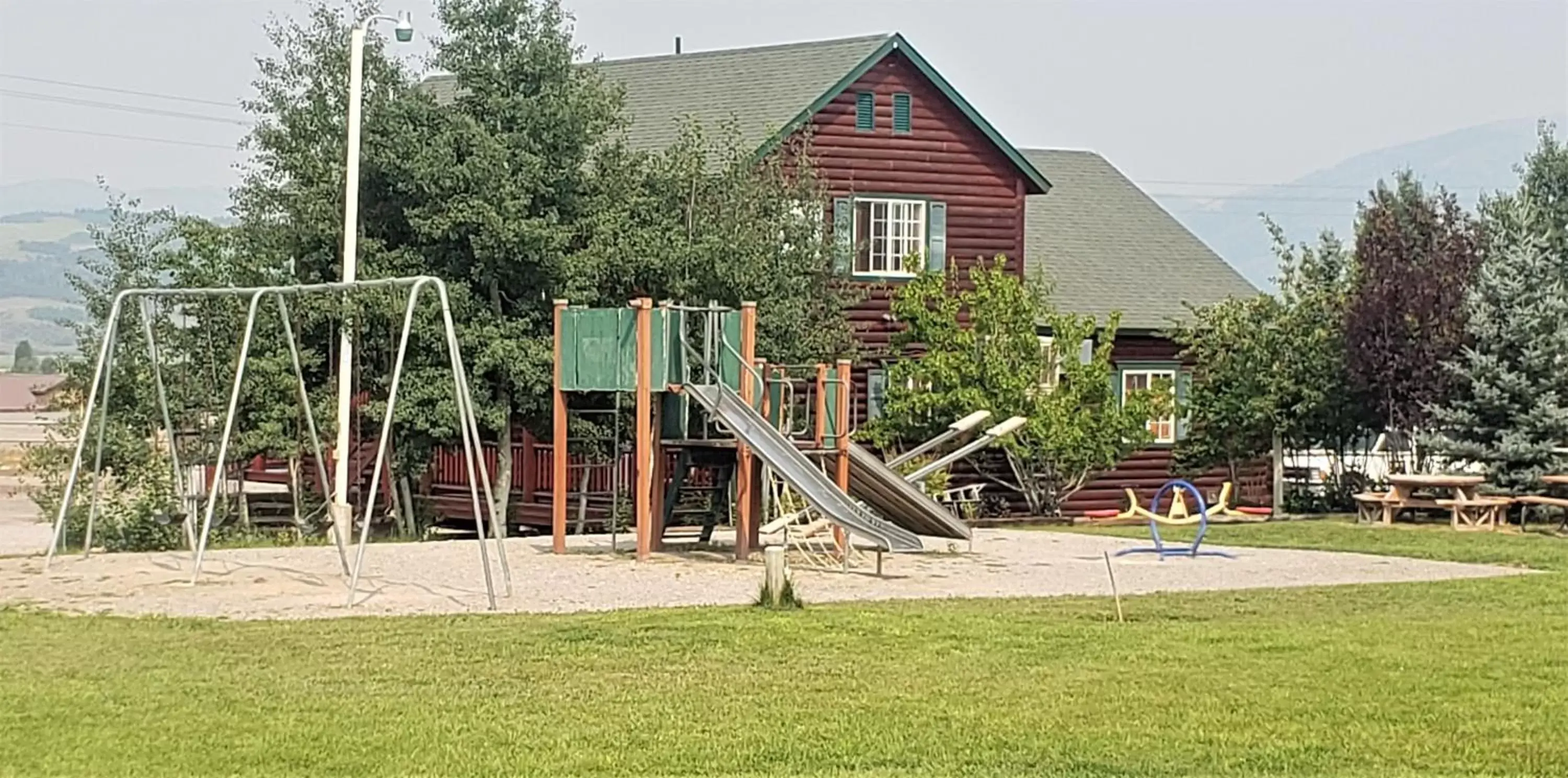 Children play ground, Property Building in Wolf Den Log Cabin Motel and RV Park
