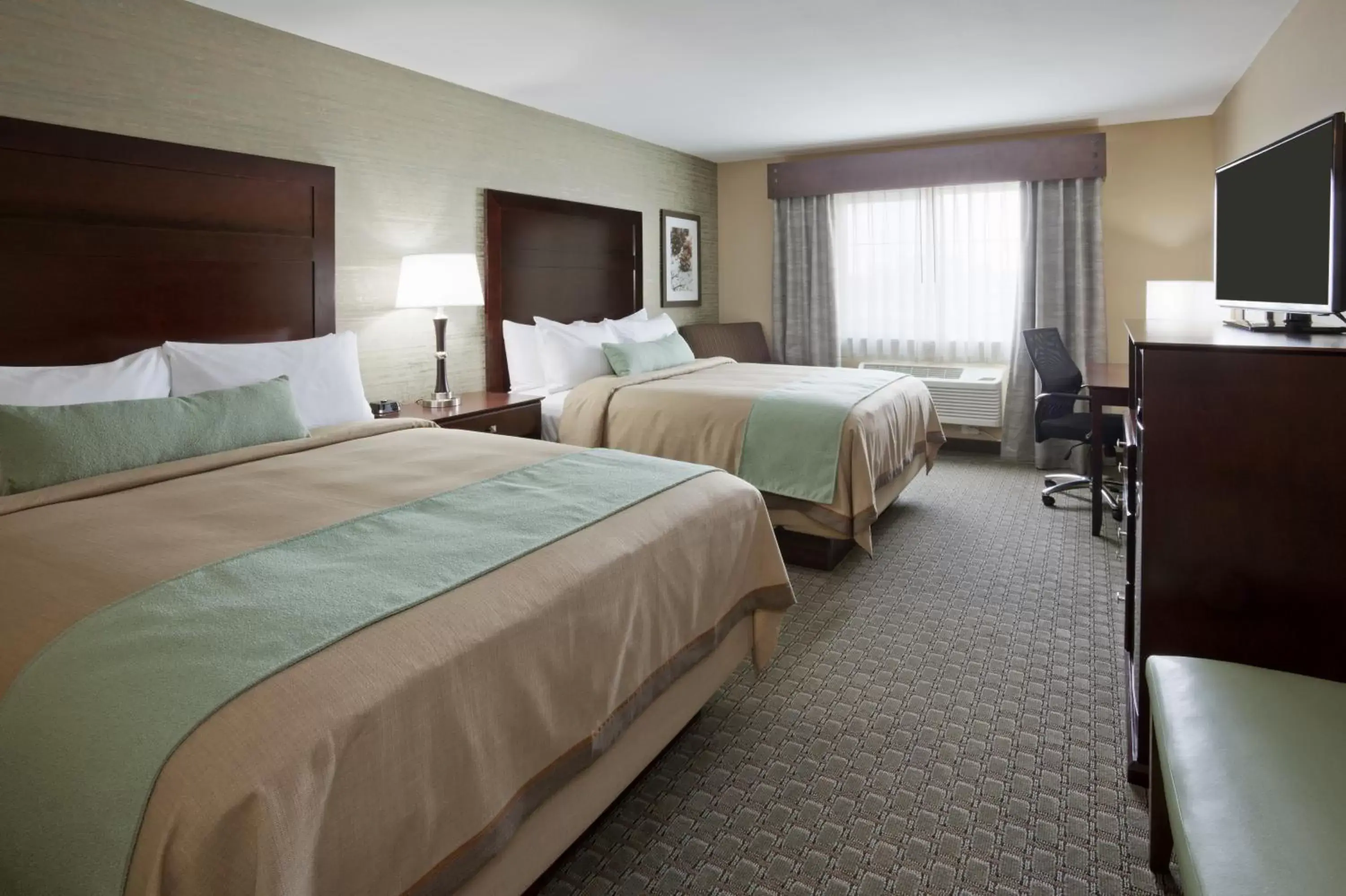 Bed in GrandStay Hotel & Suites - Morris