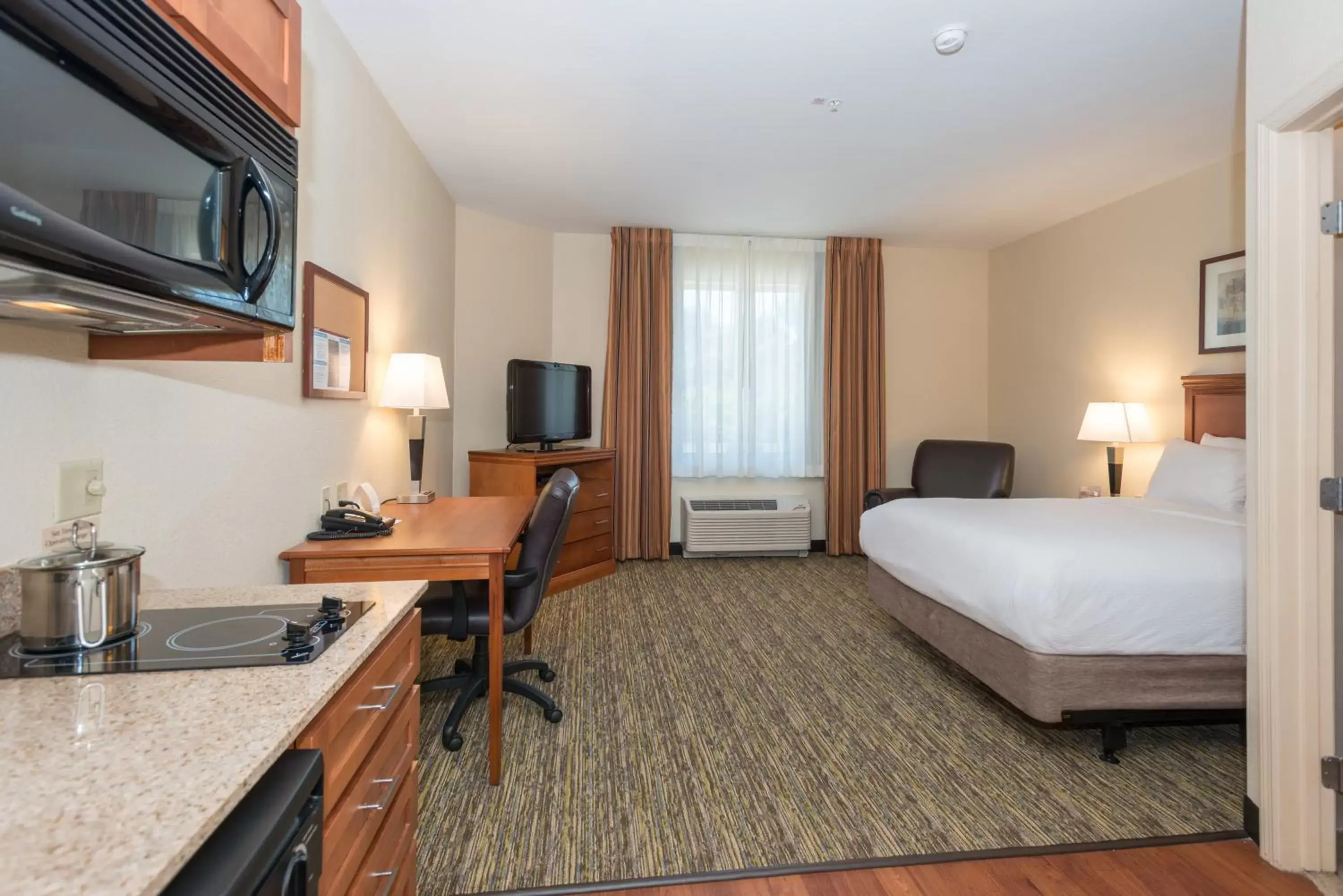 Bedroom, TV/Entertainment Center in Candlewood Suites Mobile-Downtown, an IHG Hotel