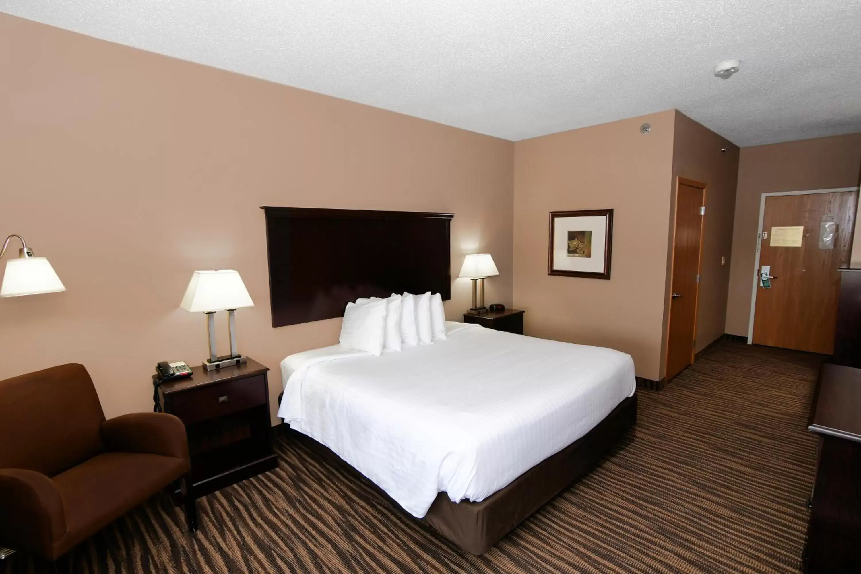 Bed in Cobblestone Inn & Suites - Denison | Majestic Hills