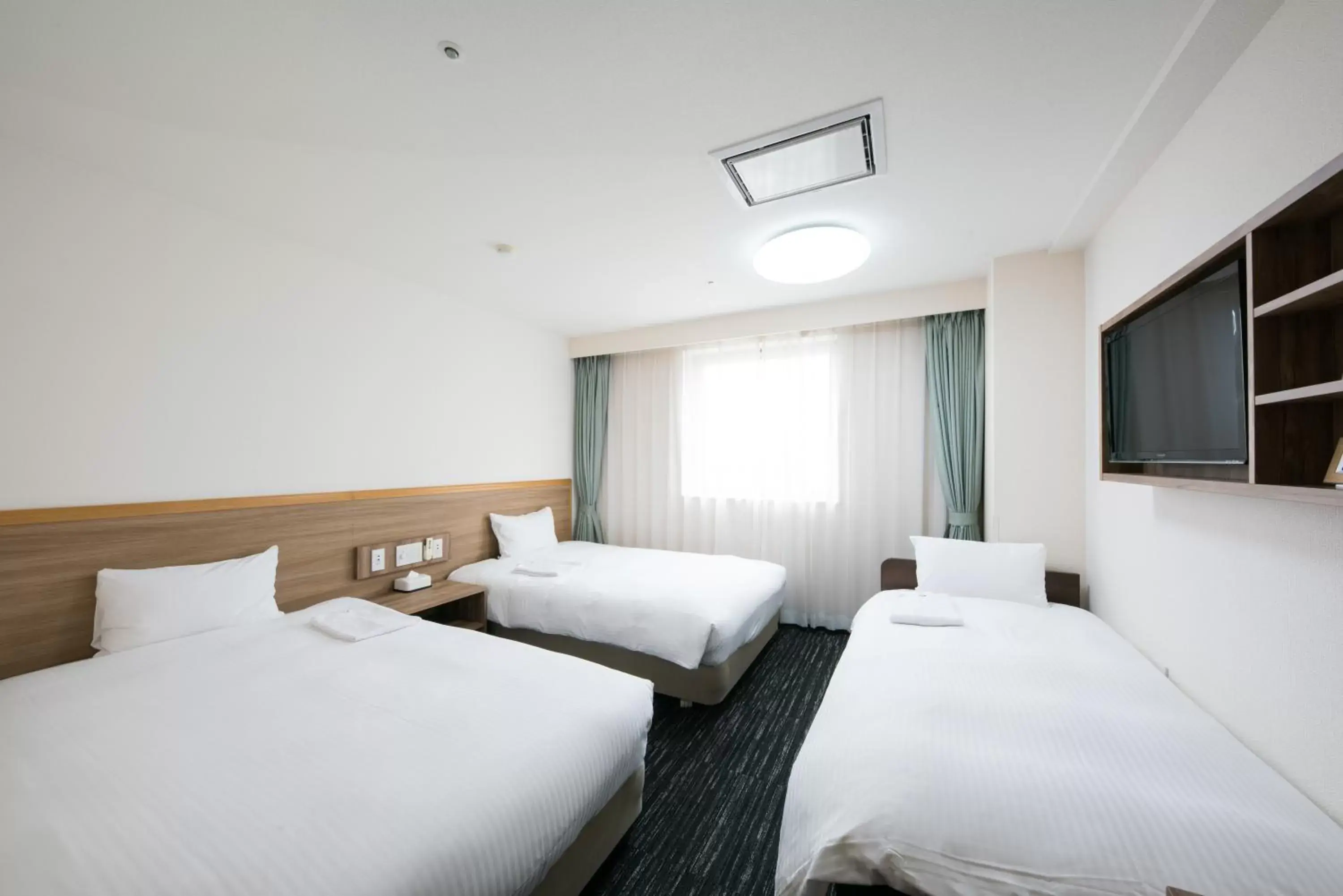 Bed in Hotel Wing International Tomakomai